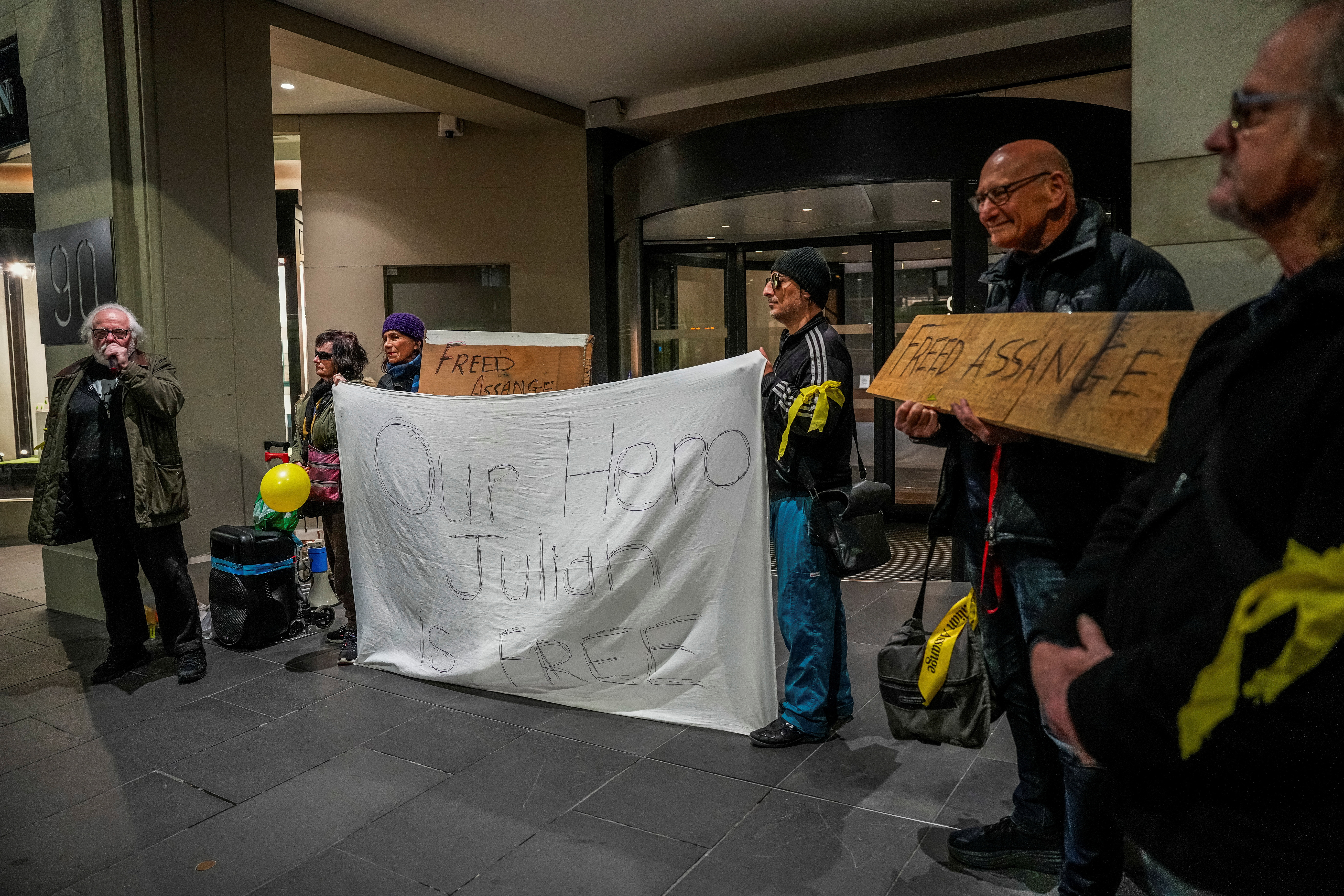 People attend an event celebrating news of the release of WikiLeaks founder Julian Assange at the British Consulate in Melbourne