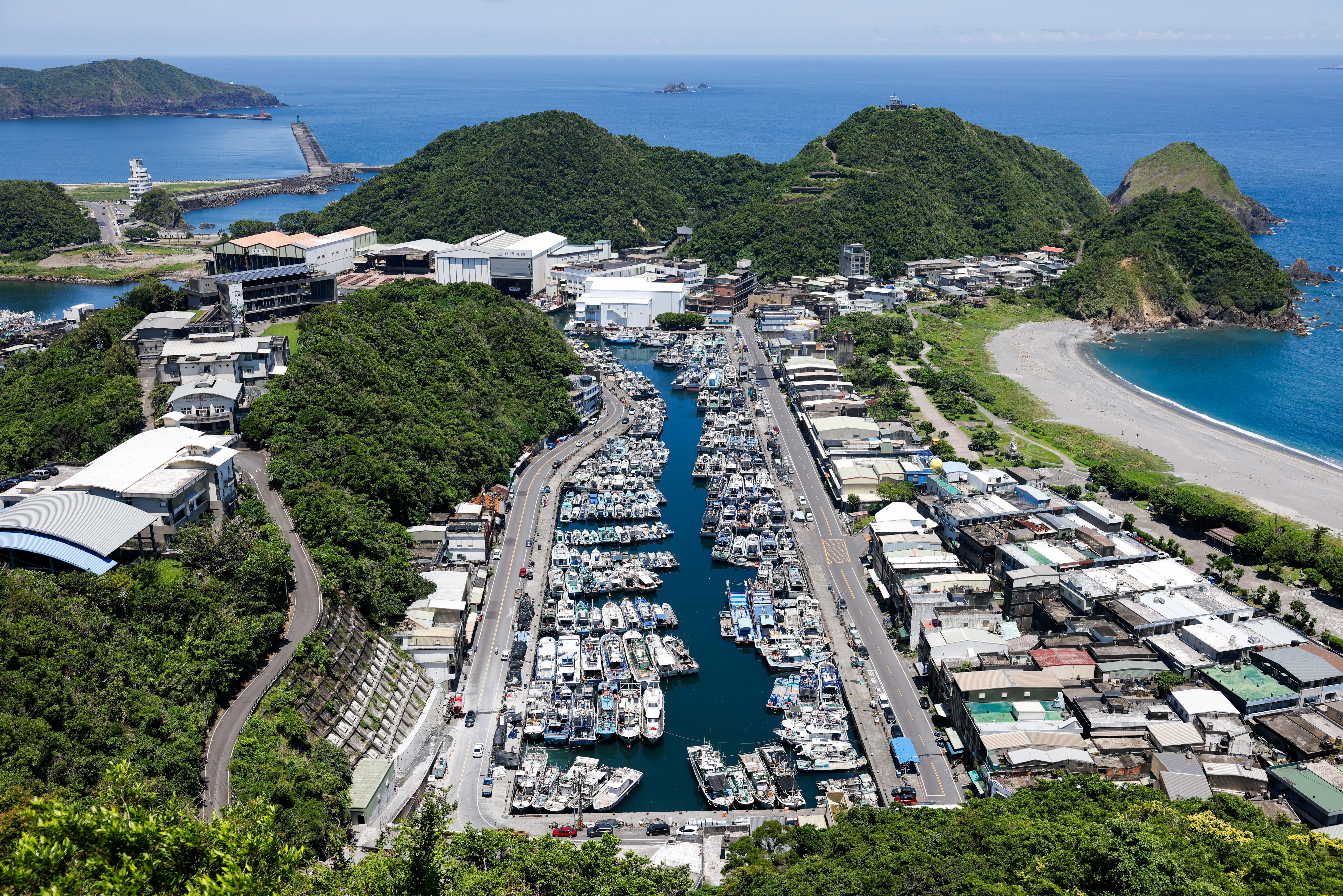 Fishing boats are docked inside a port, as Typhoon Podul approaches, in Yilan