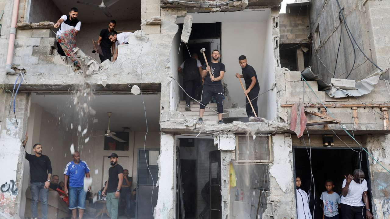 People inspect the damage following an Israeli military operation, in Tulkarm