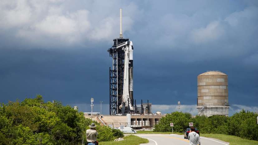 FILE PHOTO: A SpaceX Falcon 9 rocket is prepared for launch of Polaris Dawn, a private human spaceflight mission, as photographers look on at the Kennedy Space Center in Cape Canaveral,