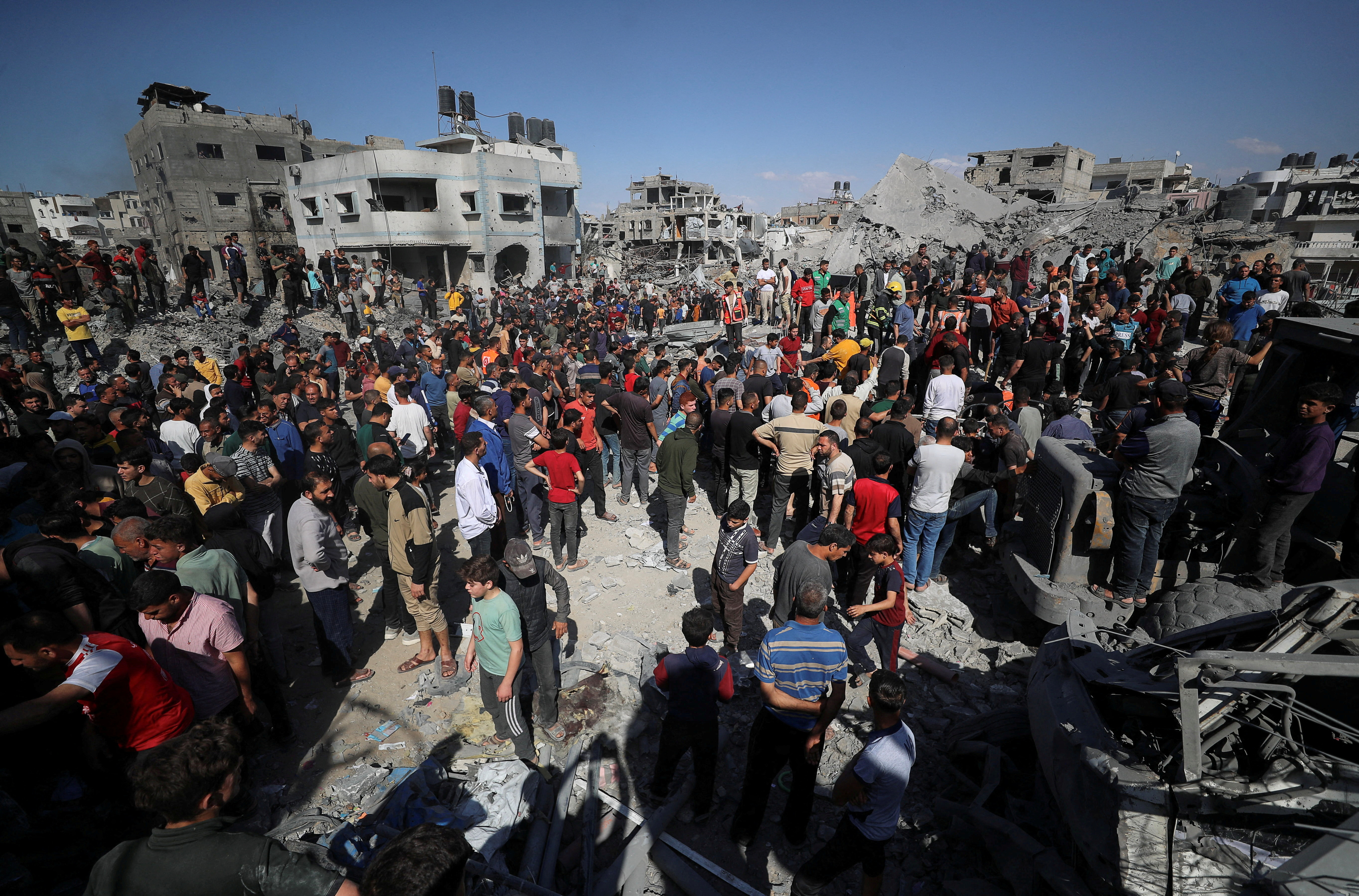 Palestinians search for casualties at the site of an Israeli strike on a house in Jabalia
