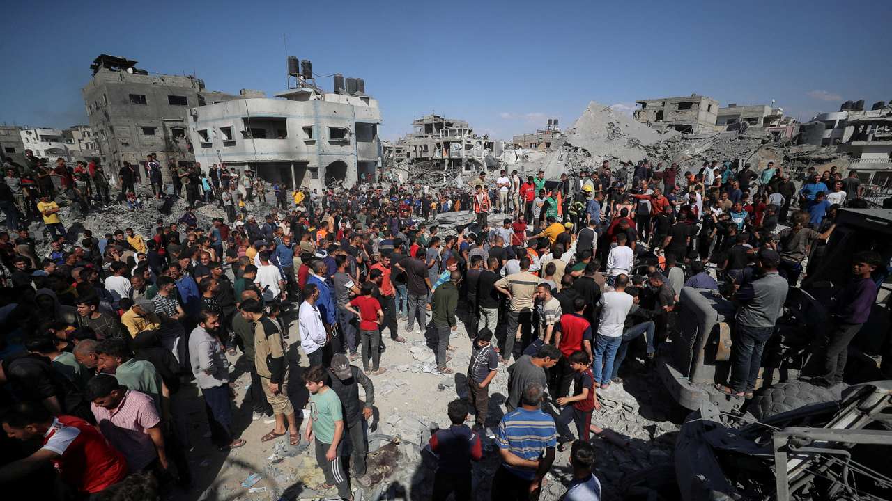 Palestinians search for casualties at the site of an Israeli strike on a house in Jabalia