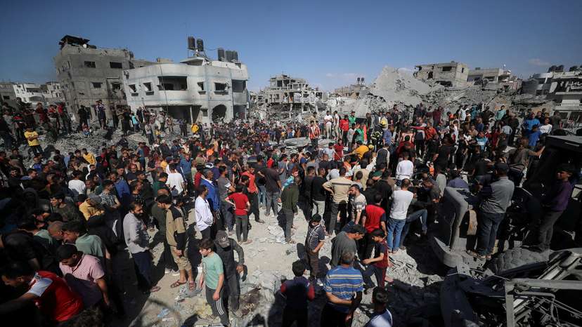 Palestinians search for casualties at the site of an Israeli strike on a house in Jabalia