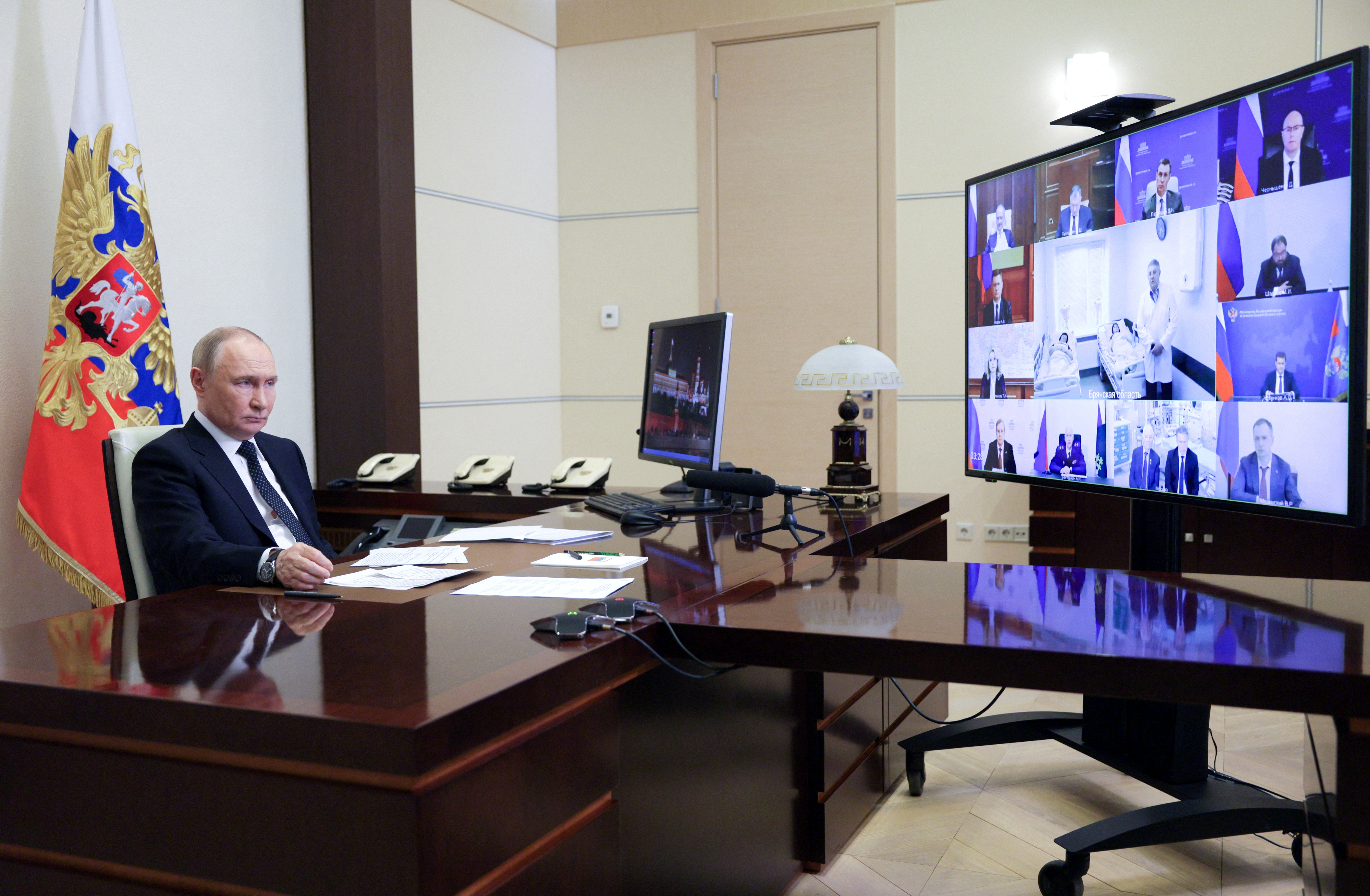Russian President Putin chairs a meeting with members of the government via video link at a residence outside Moscow
