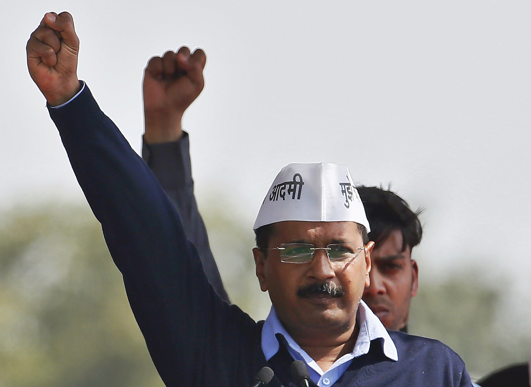Kejriwal, chief of AAP shouts slogans after taking the oath as the new chief minister of Delhi during a swearing-in ceremony at Ramlila ground in New Delhi