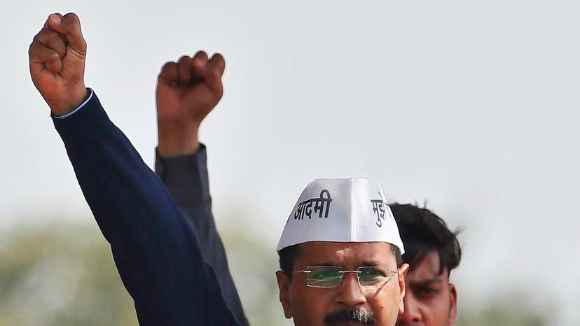 Kejriwal, chief of AAP shouts slogans after taking the oath as the new chief minister of Delhi during a swearing-in ceremony at Ramlila ground in New Delhi