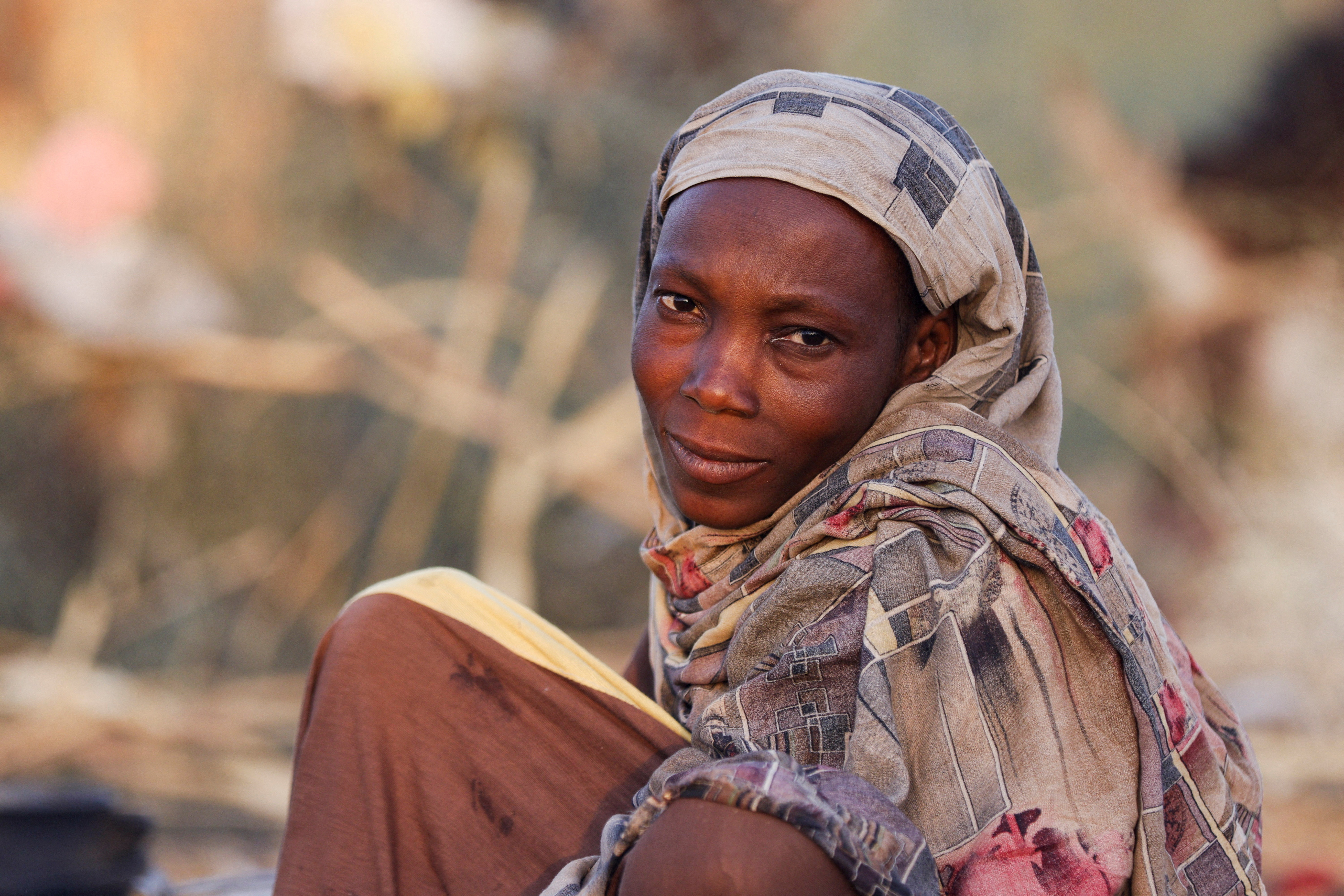 Najlaa Ahmed, a displaced Sudanese mother looks on after following by RSF attacks on Zamzam camp shelter in Tawila
