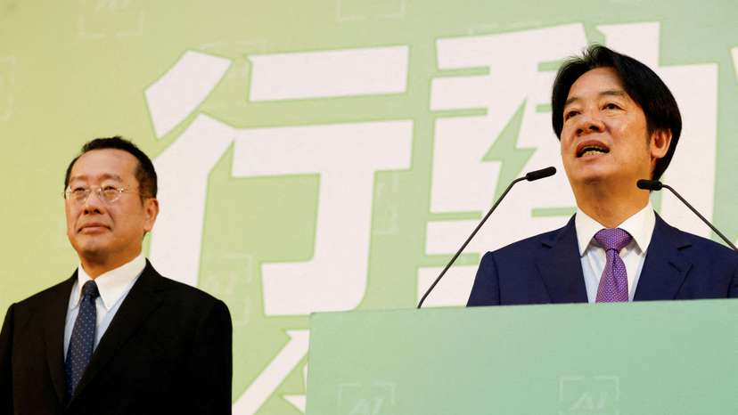 FILE PHOTO: Taiwan President-elect Lai Ching-te speaks as incoming Defence Minister Wellington Koo stands next to him during a press conference, in Taipei