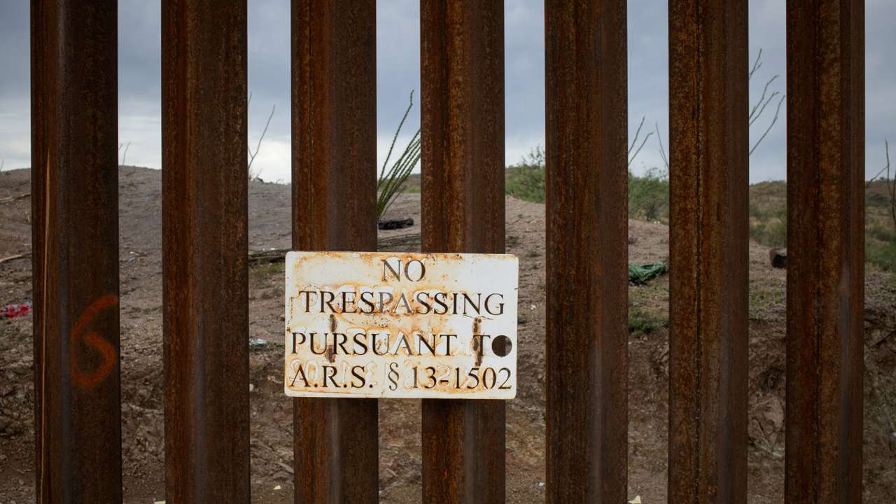 FILE PHOTO: "No Trespassing," sign is seen attached along the Border Wall in Ruby, Arizona,
