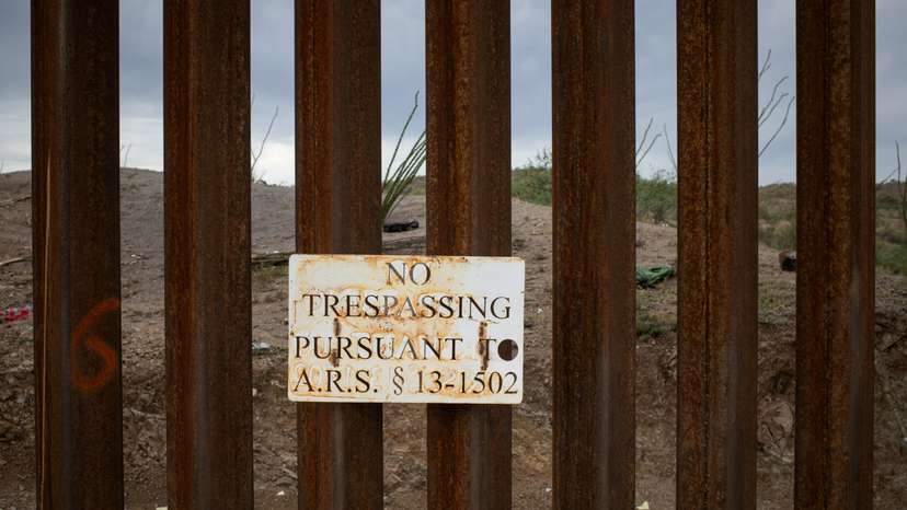 FILE PHOTO: "No Trespassing," sign is seen attached along the Border Wall in Ruby, Arizona,