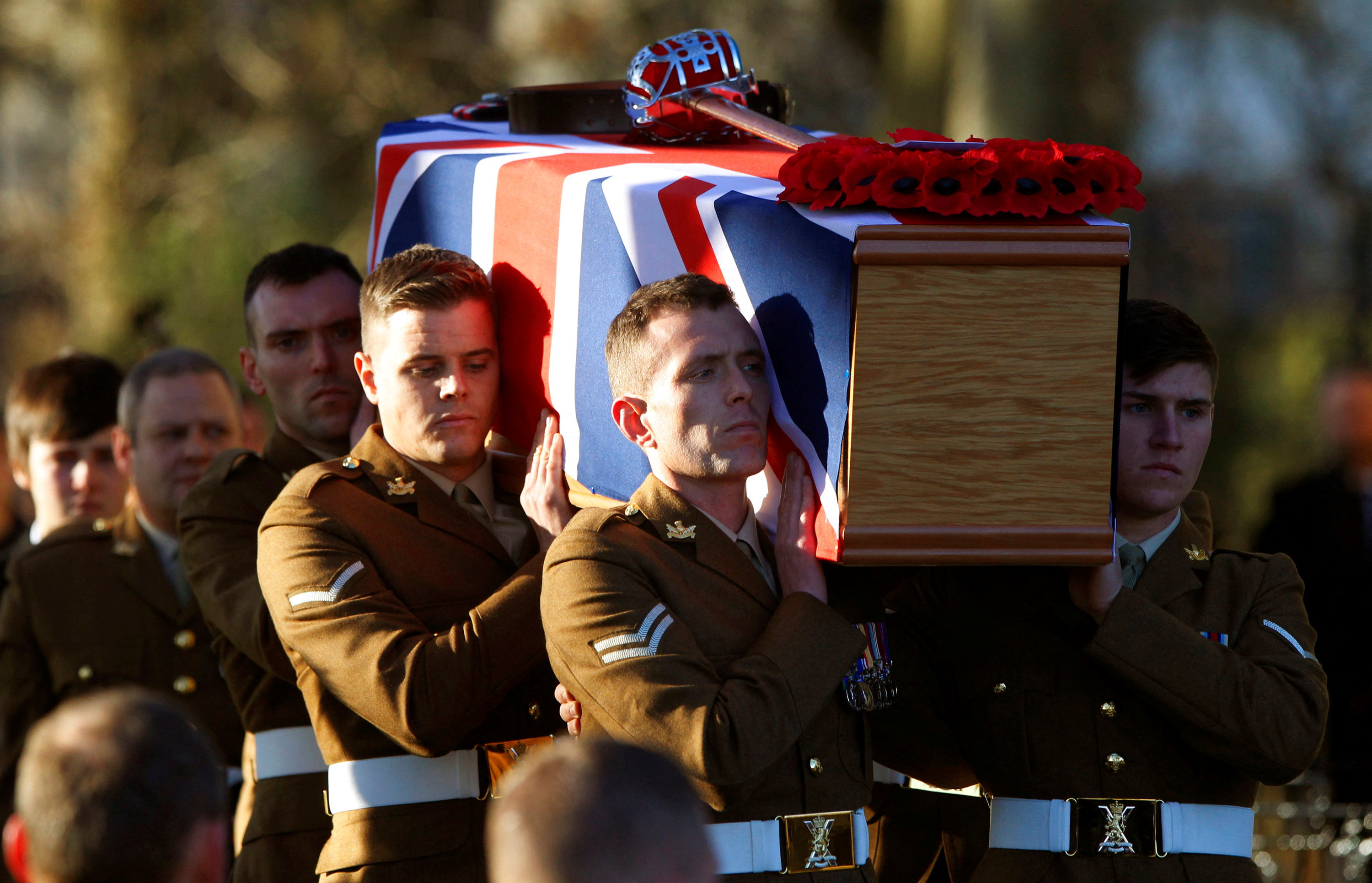 FILE PHOTO: Soldiers from the Royal Regiment of Scotland carry the coffin of Captain Walter Barrie after his funeral service at Glencorse Kirk near Edinburgh, Scotland