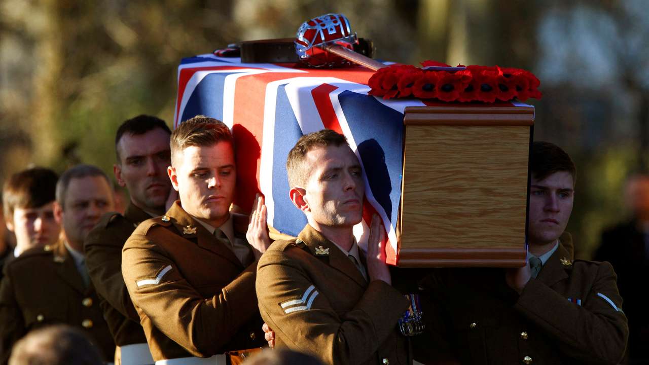 FILE PHOTO: Soldiers from the Royal Regiment of Scotland carry the coffin of Captain Walter Barrie after his funeral service at Glencorse Kirk near Edinburgh, Scotland