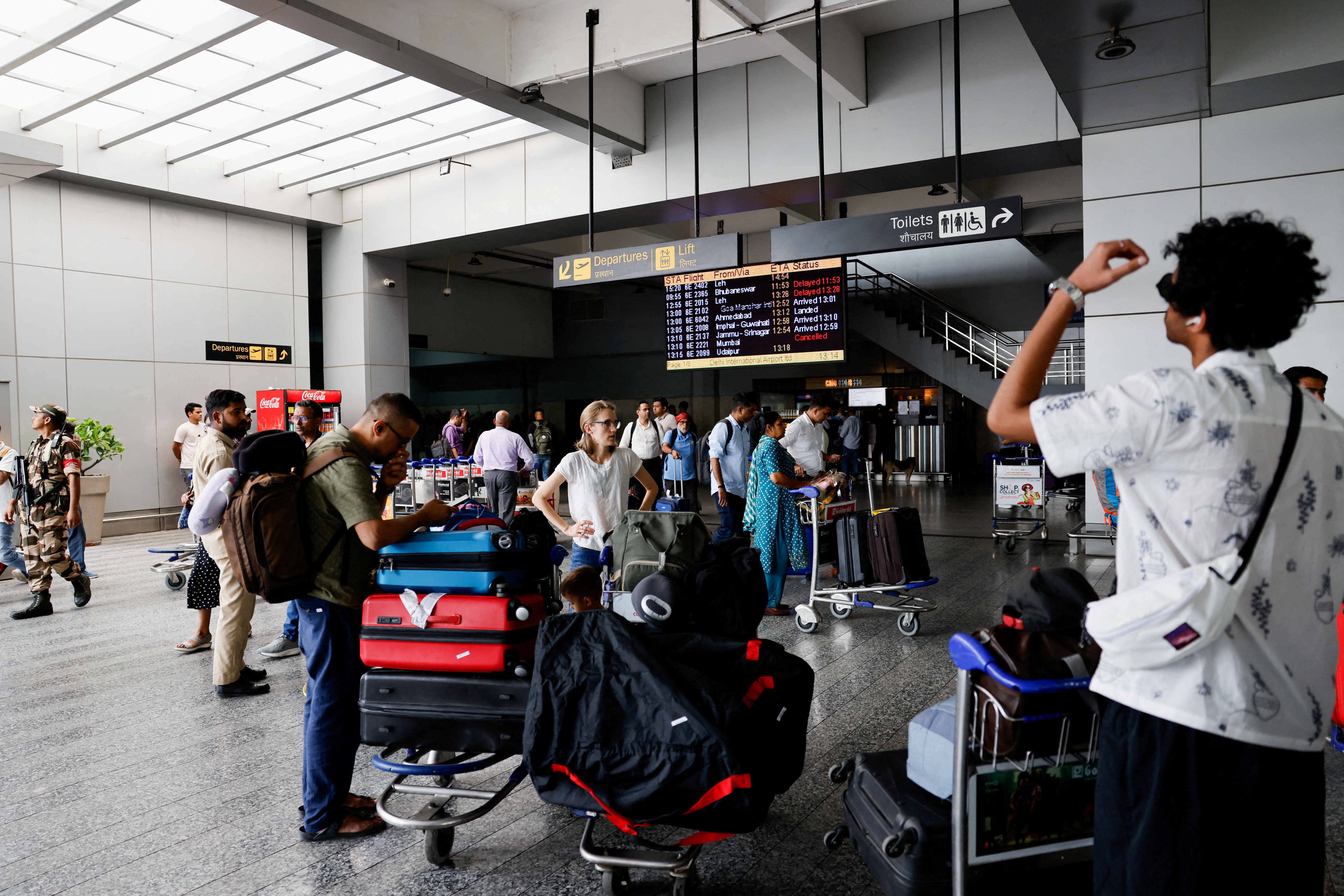 FILE PHOTO: Passengers wait at Terminal 2 of Indira Gandhi International Airport in New Delhi