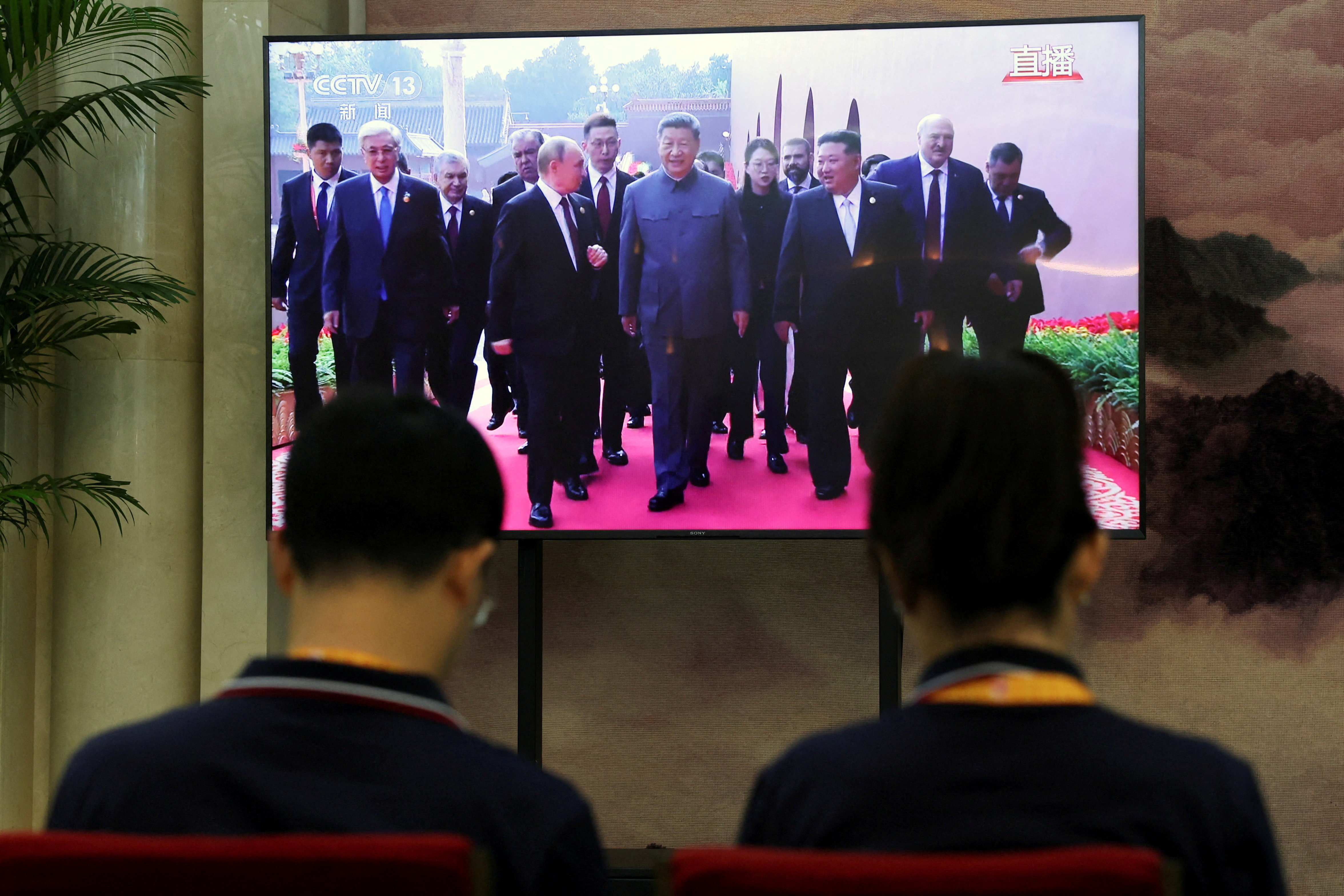 TV screen showing military parade in Beijing