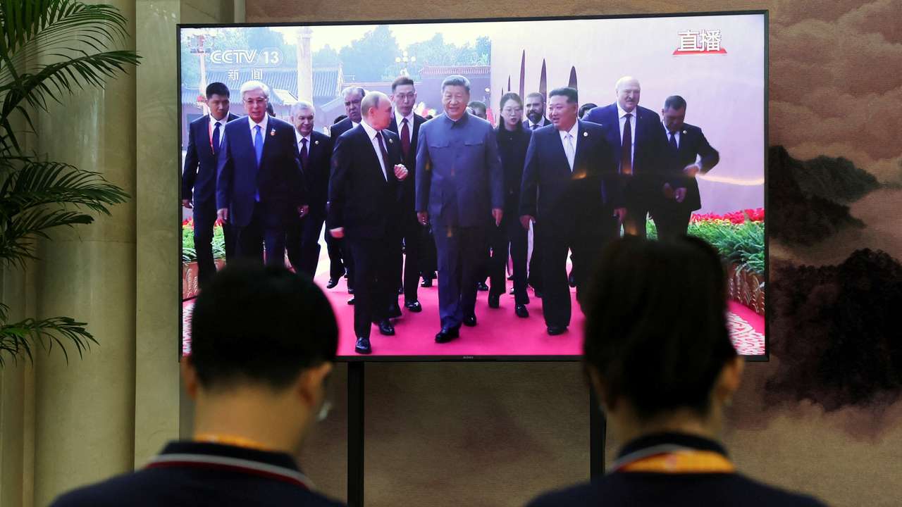TV screen showing military parade in Beijing