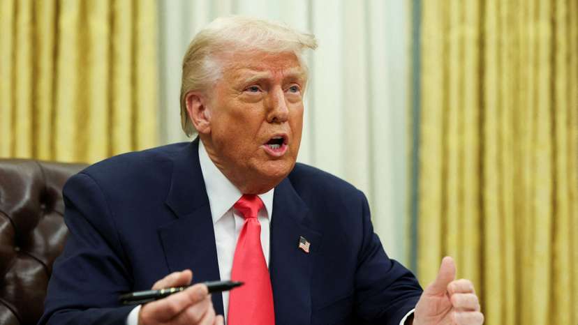 FILE PHOTO: U.S. President Donald Trump signs executive orders in the Oval Office, at the White House in Washington, D.C.