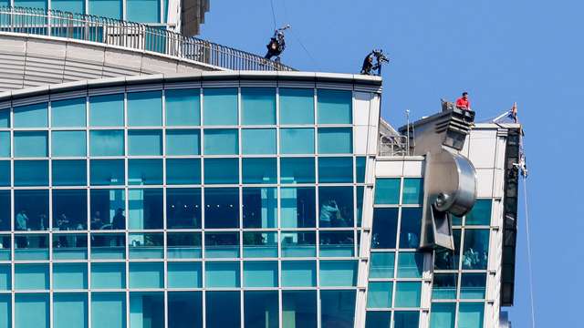 Climber Alex Honnold takes a break while free soloing Taipei 101 Skyscraper in Taipei