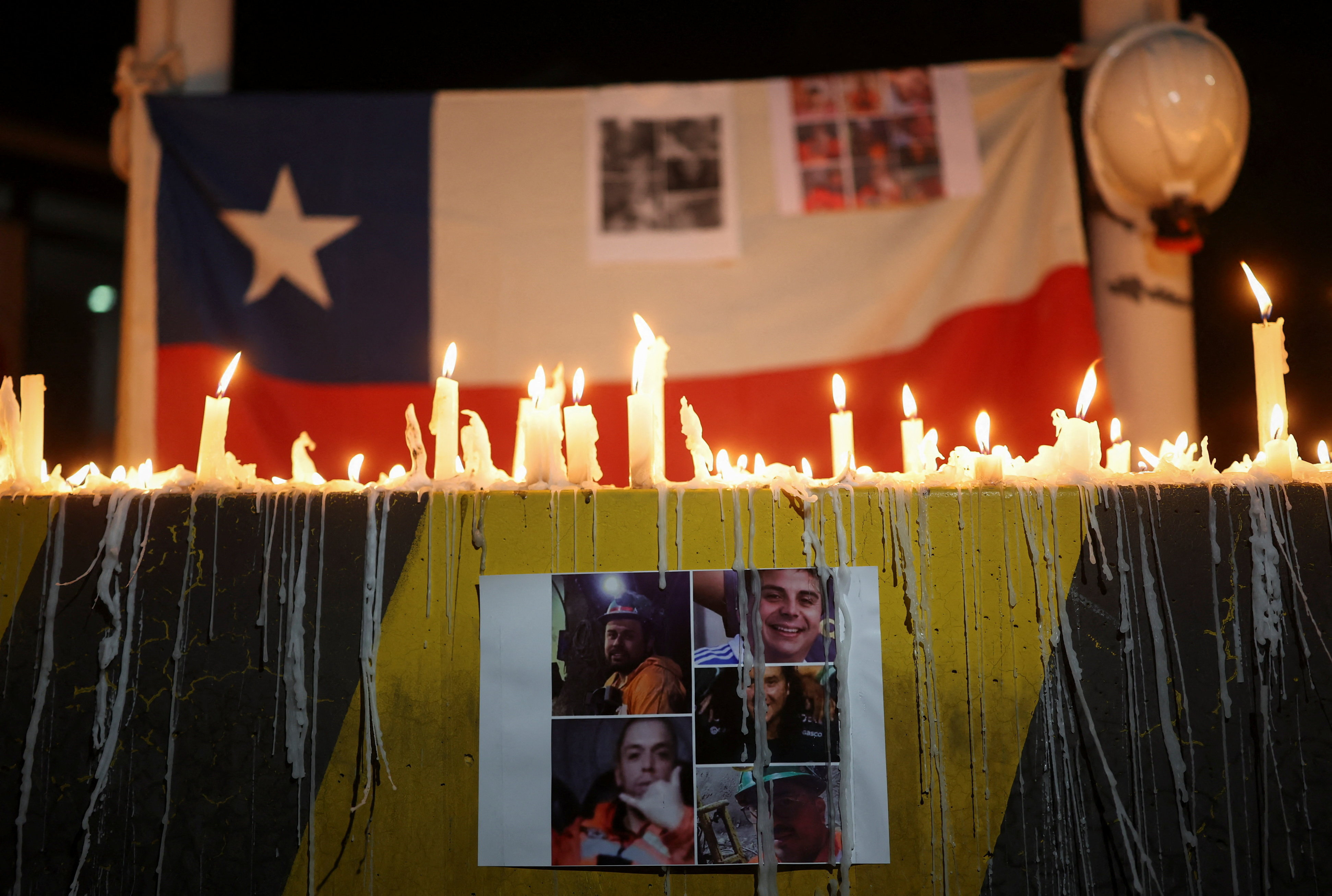 A print showing photos of miners who were trapped in the El Teniente mine complex, operated by Chilean state-run copper producer Codelco
