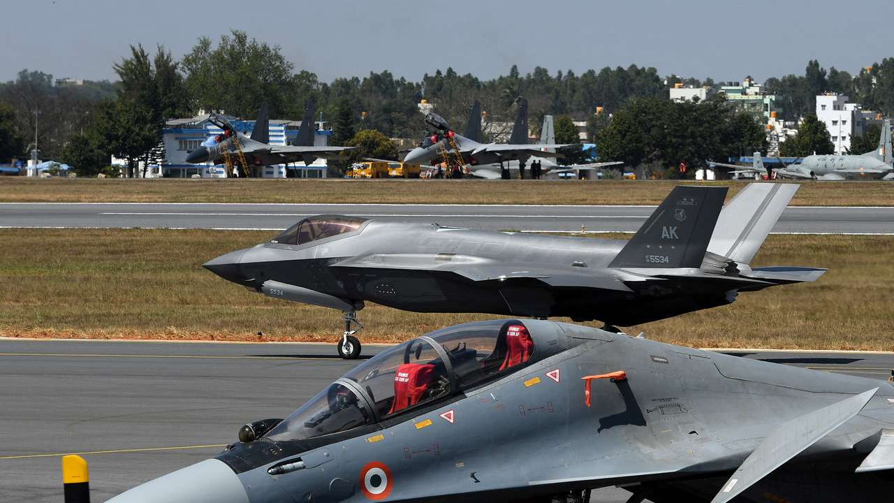 FILE PHOTO: A F-35 fighter jet moves past Indian Air Force's Sukhoi Su-30MKI fighter jet parked on tarmac during the "Aero India 2025" air show at Yelahanka air base in Bengaluru