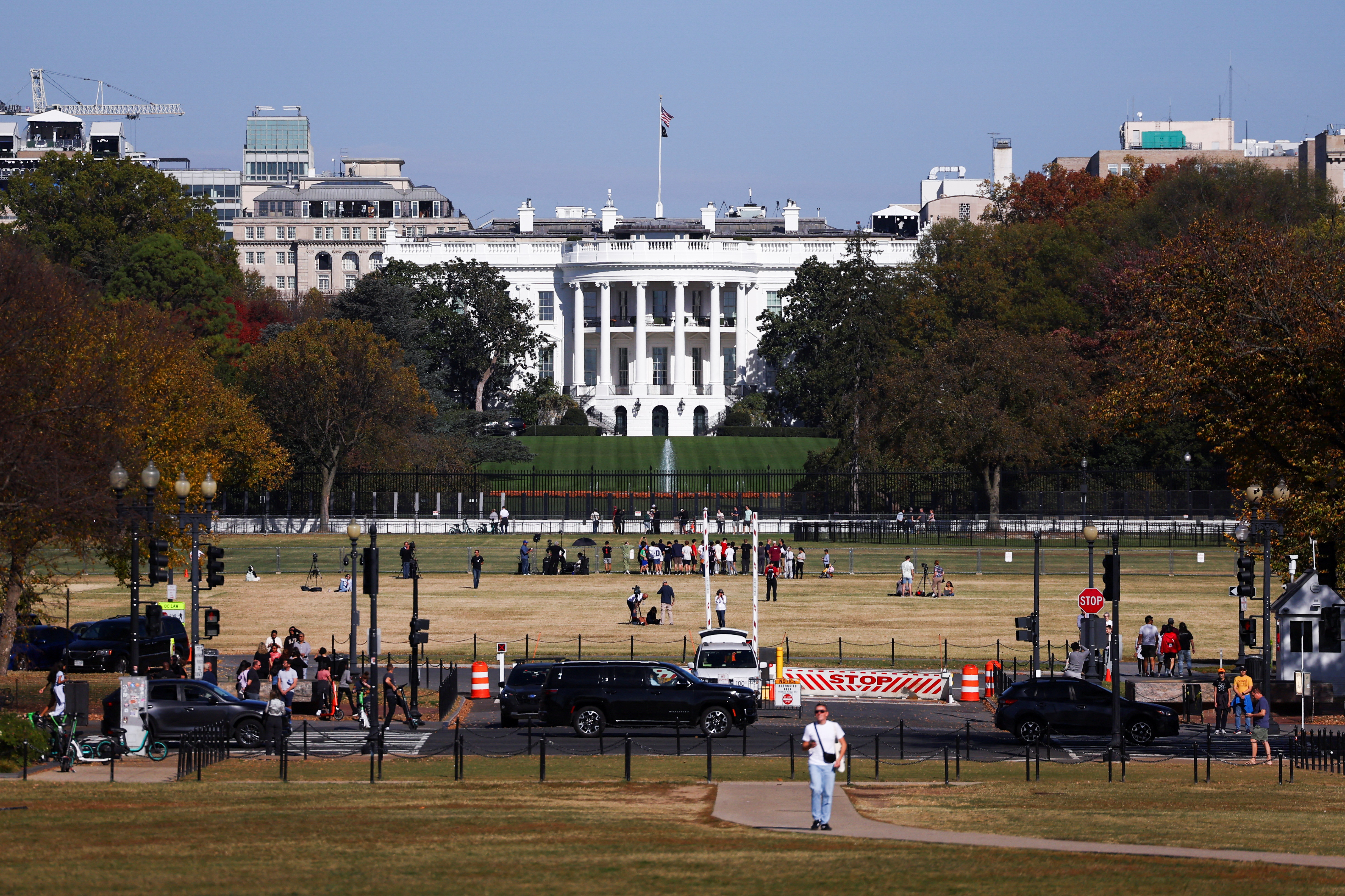 People gather outside the White House, in Washington