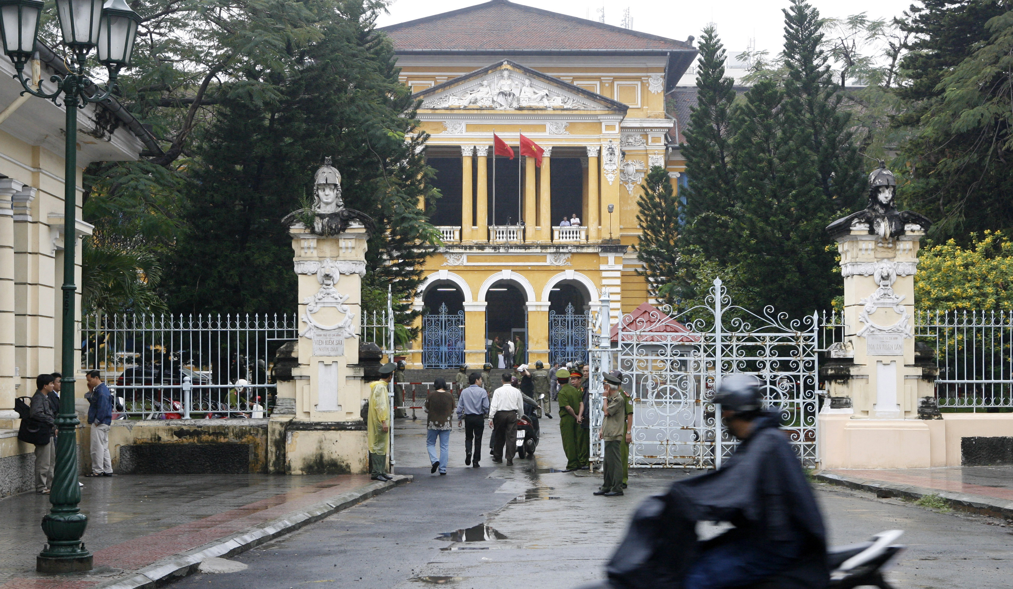 FILE PHOTO: A man rides a motorcycle past the People's Court in Ho Chi Minh city
