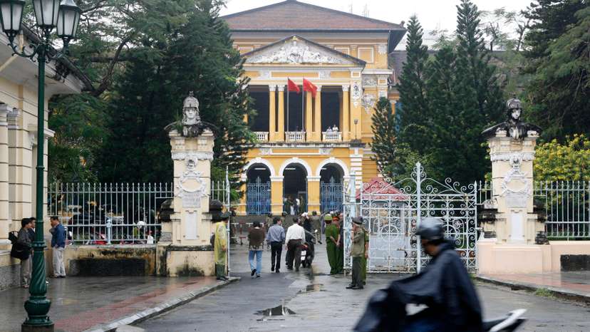 FILE PHOTO: A man rides a motorcycle past the People's Court in Ho Chi Minh city
