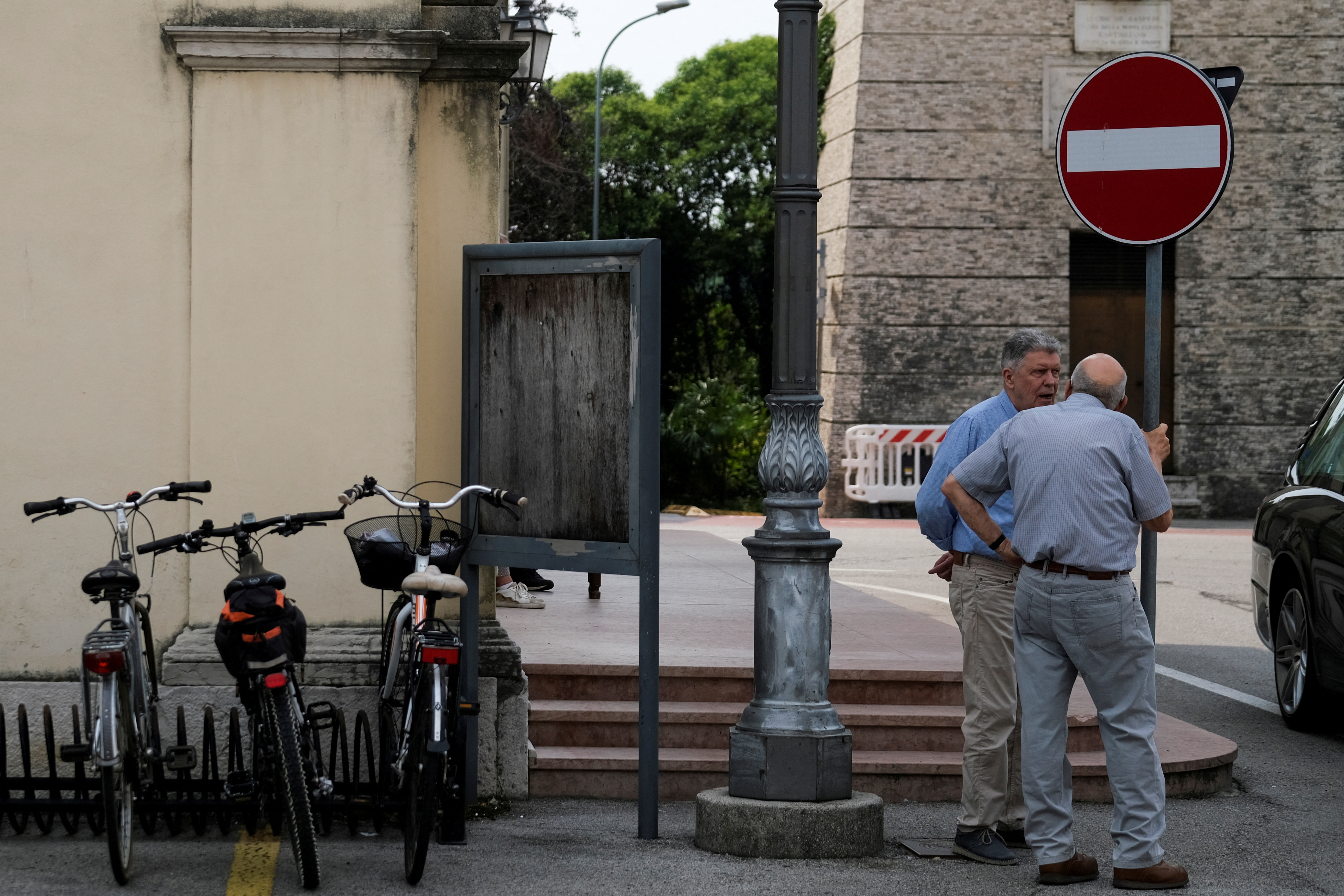 FILE PHOTO: Two elderly men speak in the square of Cartigliano