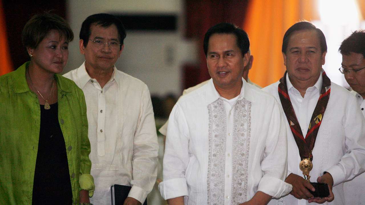 International evangelist Pastor Apollo Quiboloy (2nd R) walks with presidential candidates attending his 60th birthday celebration in Davao City