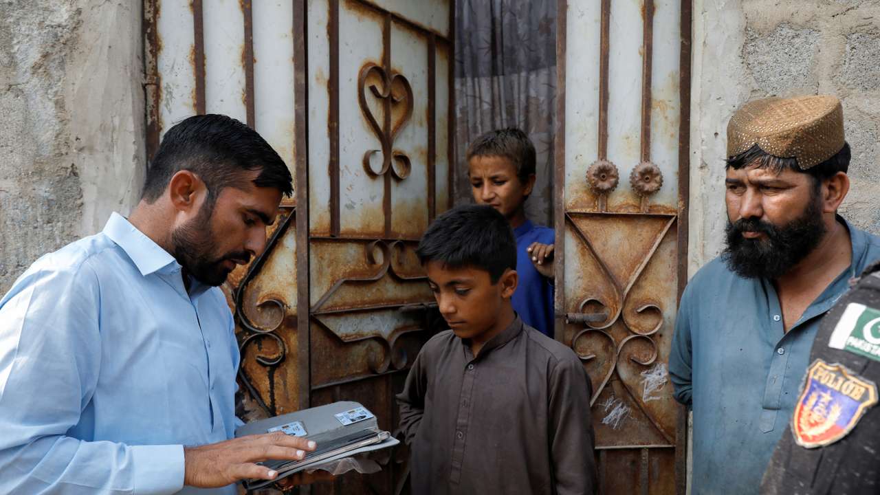 Police conduct a search and verification drive for undocumented Afghan nationals, on the outskirts of Karachi