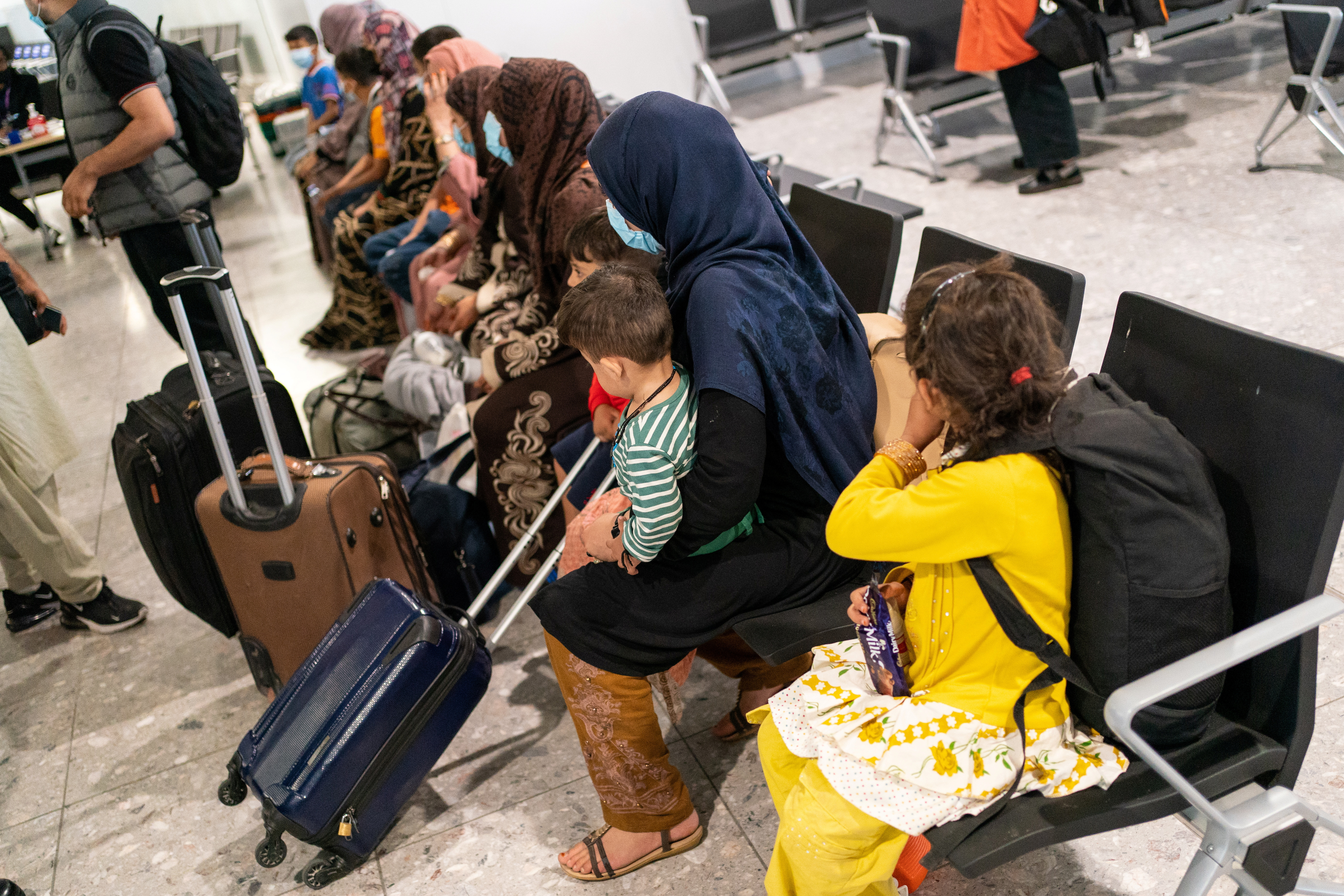 FILE PHOTO: Refugees from Afghanistan wait to be processed after arriving on an evacuation flight at Heathrow Airport
