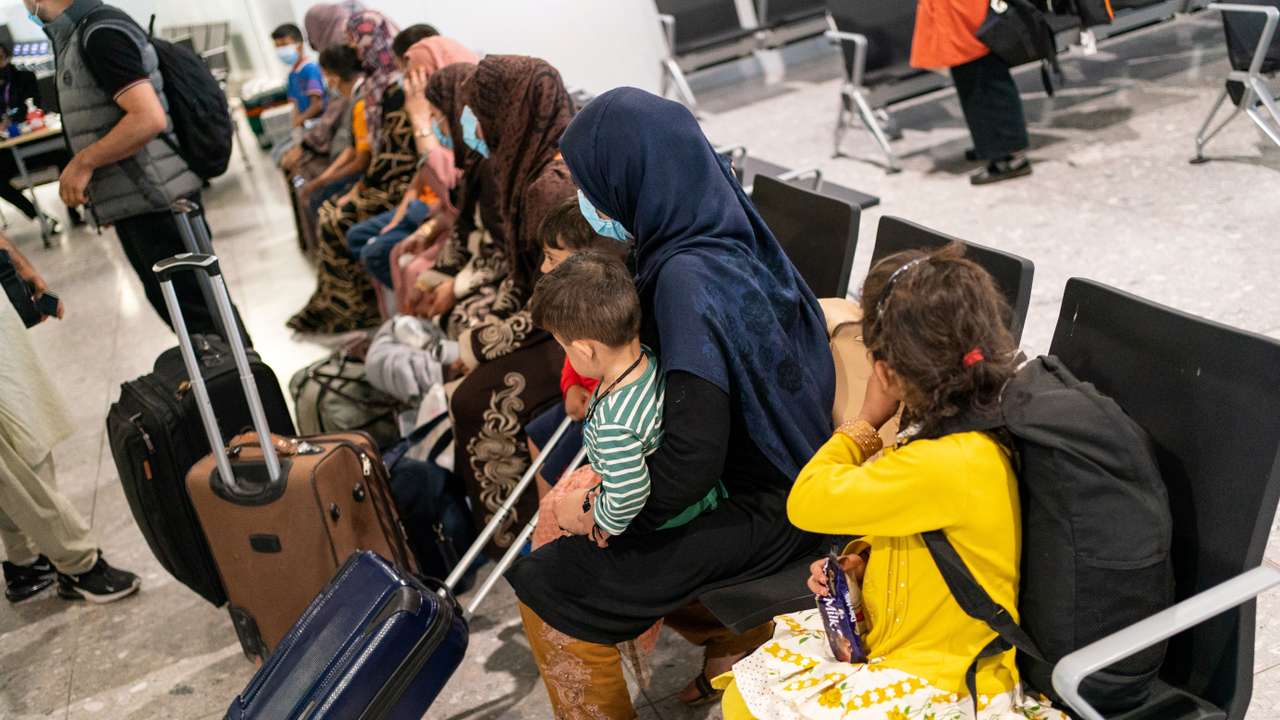 FILE PHOTO: Refugees from Afghanistan wait to be processed after arriving on an evacuation flight at Heathrow Airport