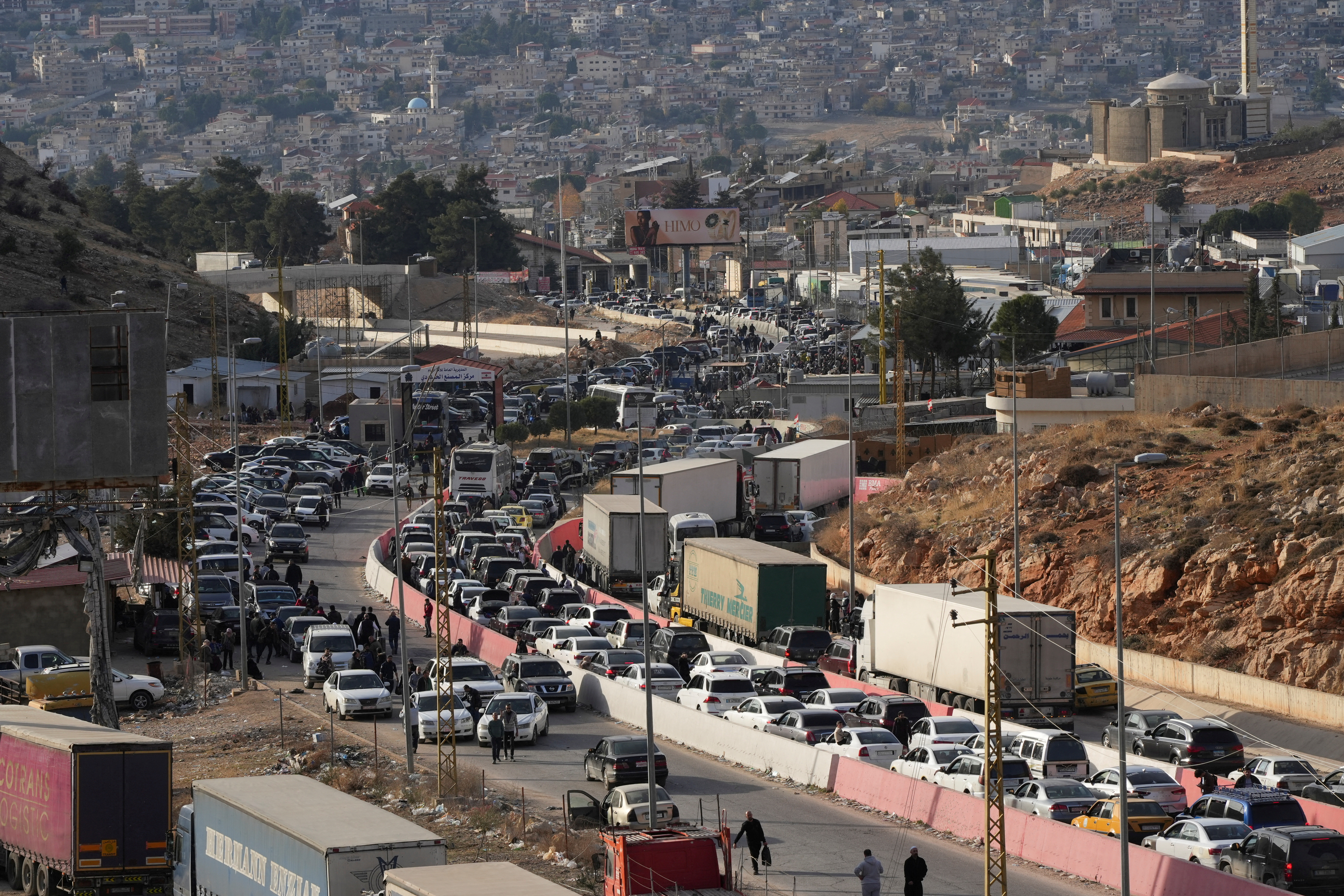 People make their way as they attempt to cross into Lebanon at the Masnaa border crossing between the Lebanon and Syria