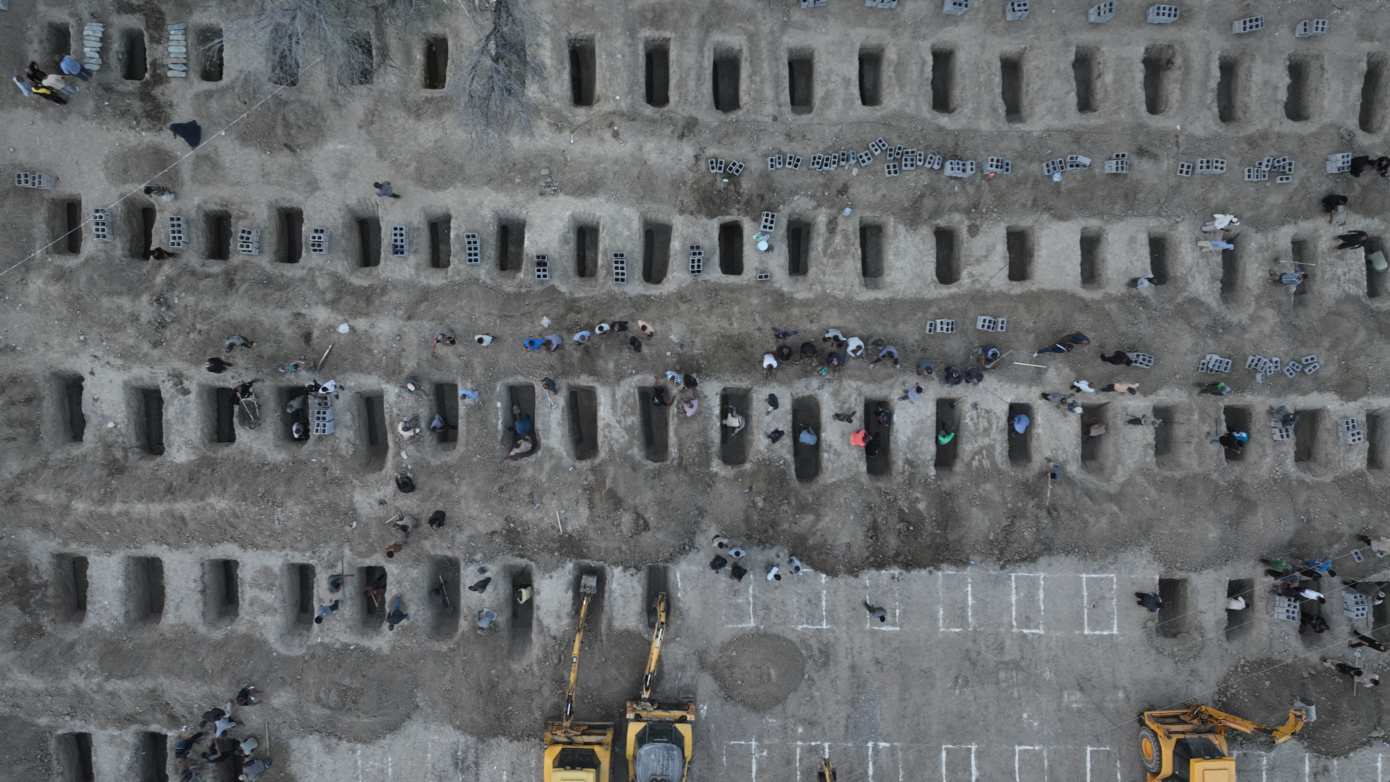 Graves are being prepared for the victims following an Israeli strike on a school in Minab