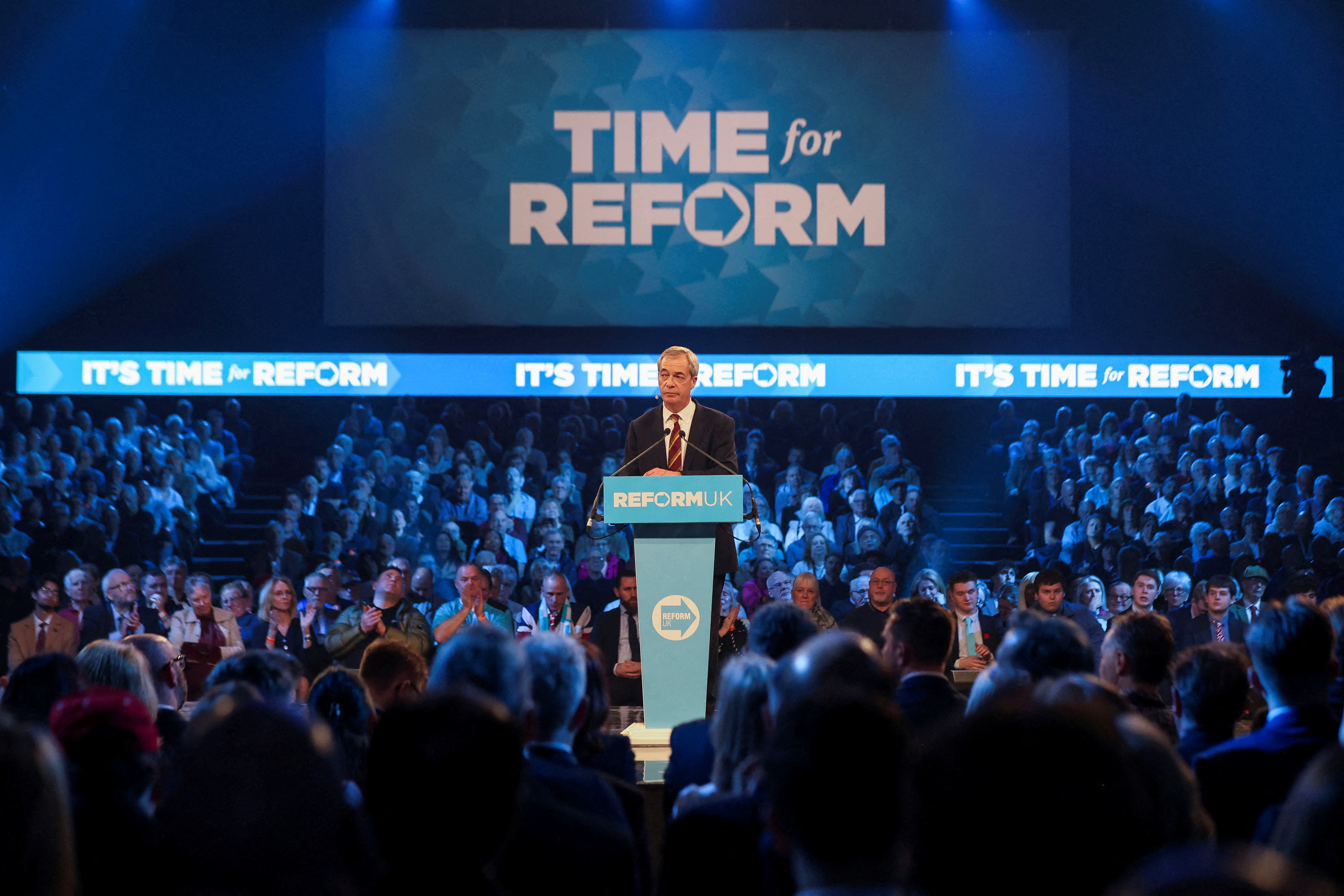 FILE PHOTO: Britain's Reform UK party leader Nigel Farage delivers a speech at a party rally in Birmingham