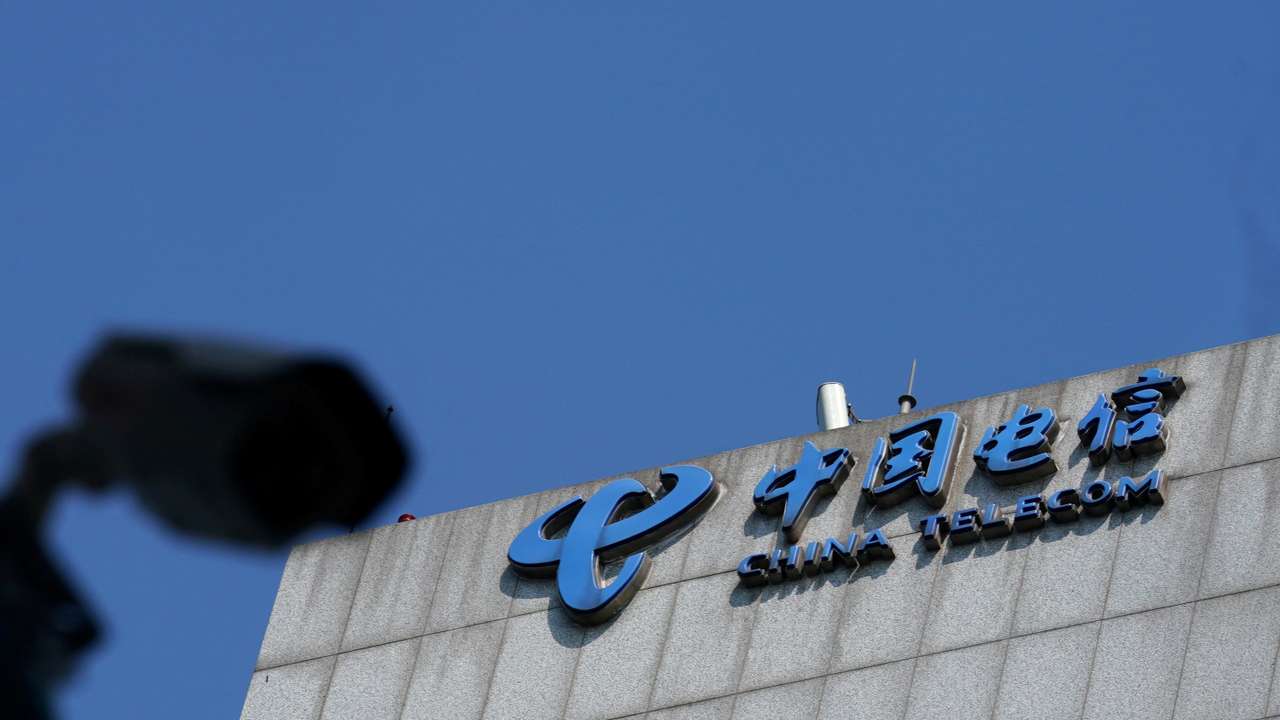 FILE PHOTO: Sign of China Telecom is pictured near a security camera in Beijing