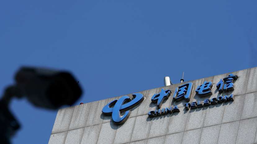 FILE PHOTO: Sign of China Telecom is pictured near a security camera in Beijing