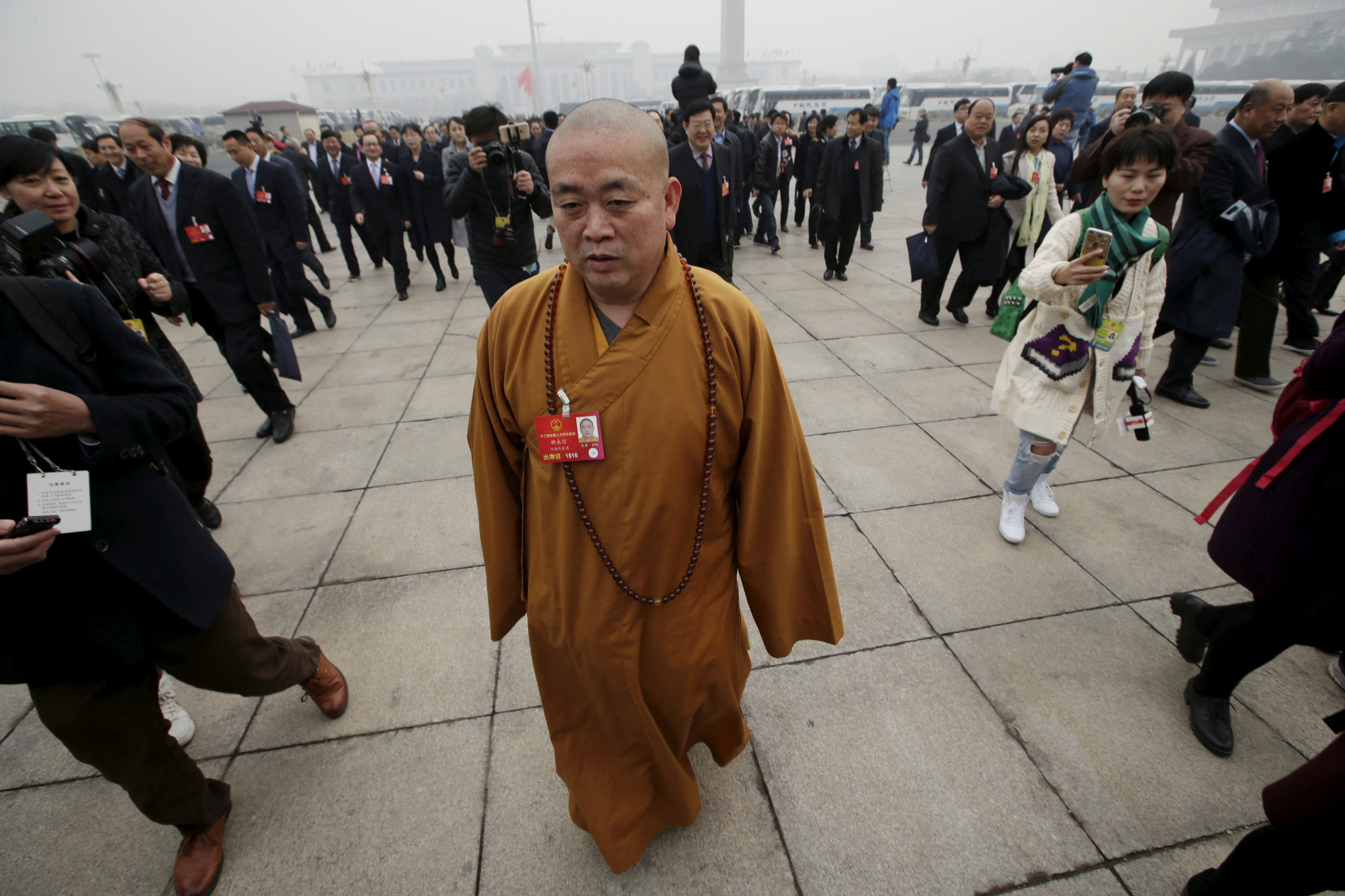 FILE PHOTO: Buddhist abbot Shi Yongxin, a delegate of the NPC, walks toward the Great Hall of the People  in Beijing