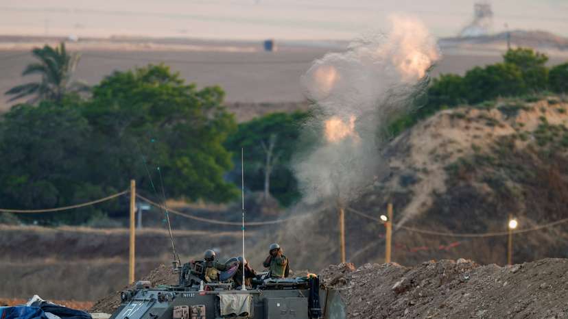 Israeli soldiers fire a mortar towards Gaza