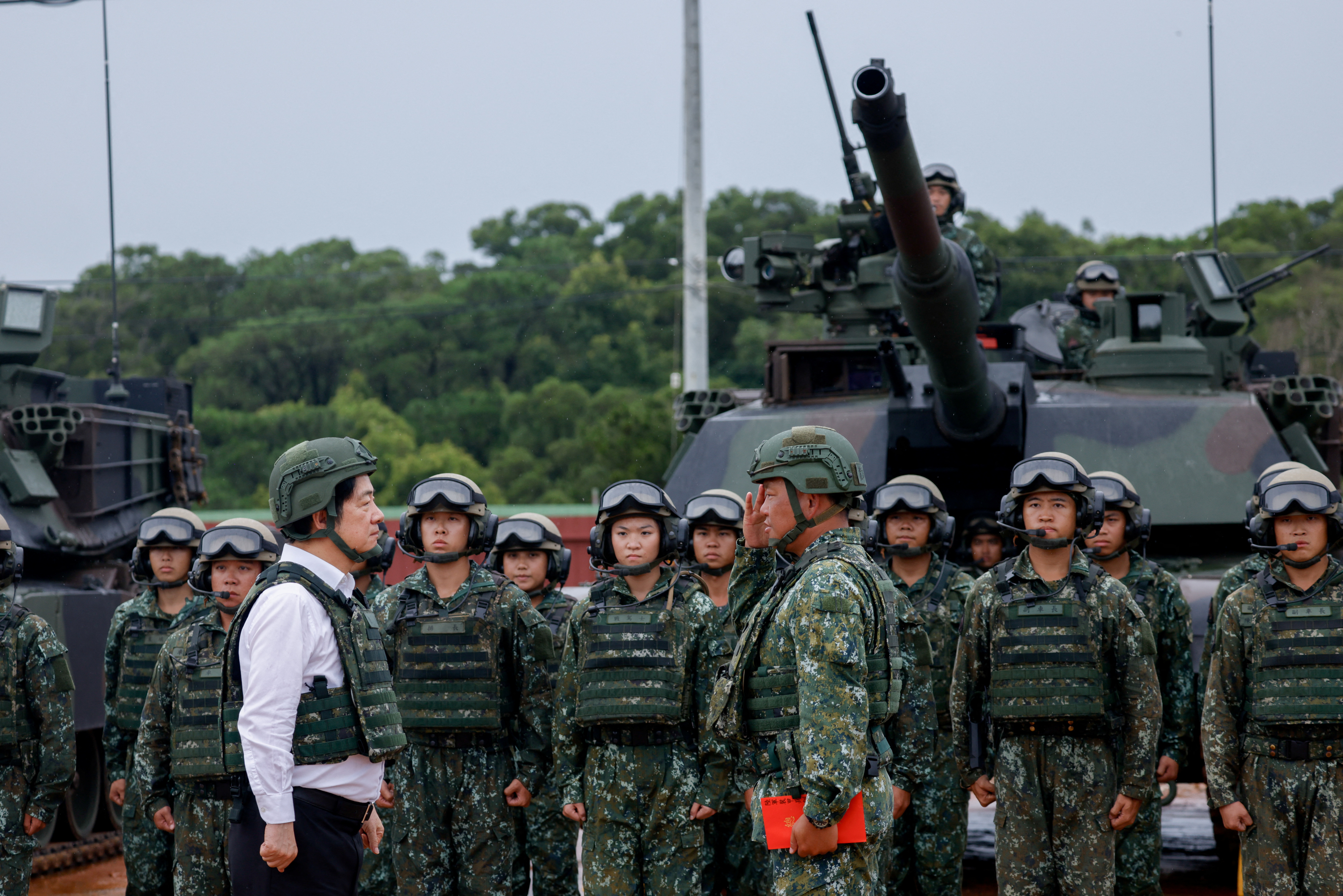 A soldier salutes Taiwan president Lai Ching-te in front of U.S.-made M1A2T Abrams tanks in Hsinchu