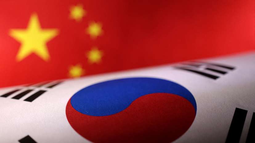 Illustration shows printed Chinese and South Korean flags