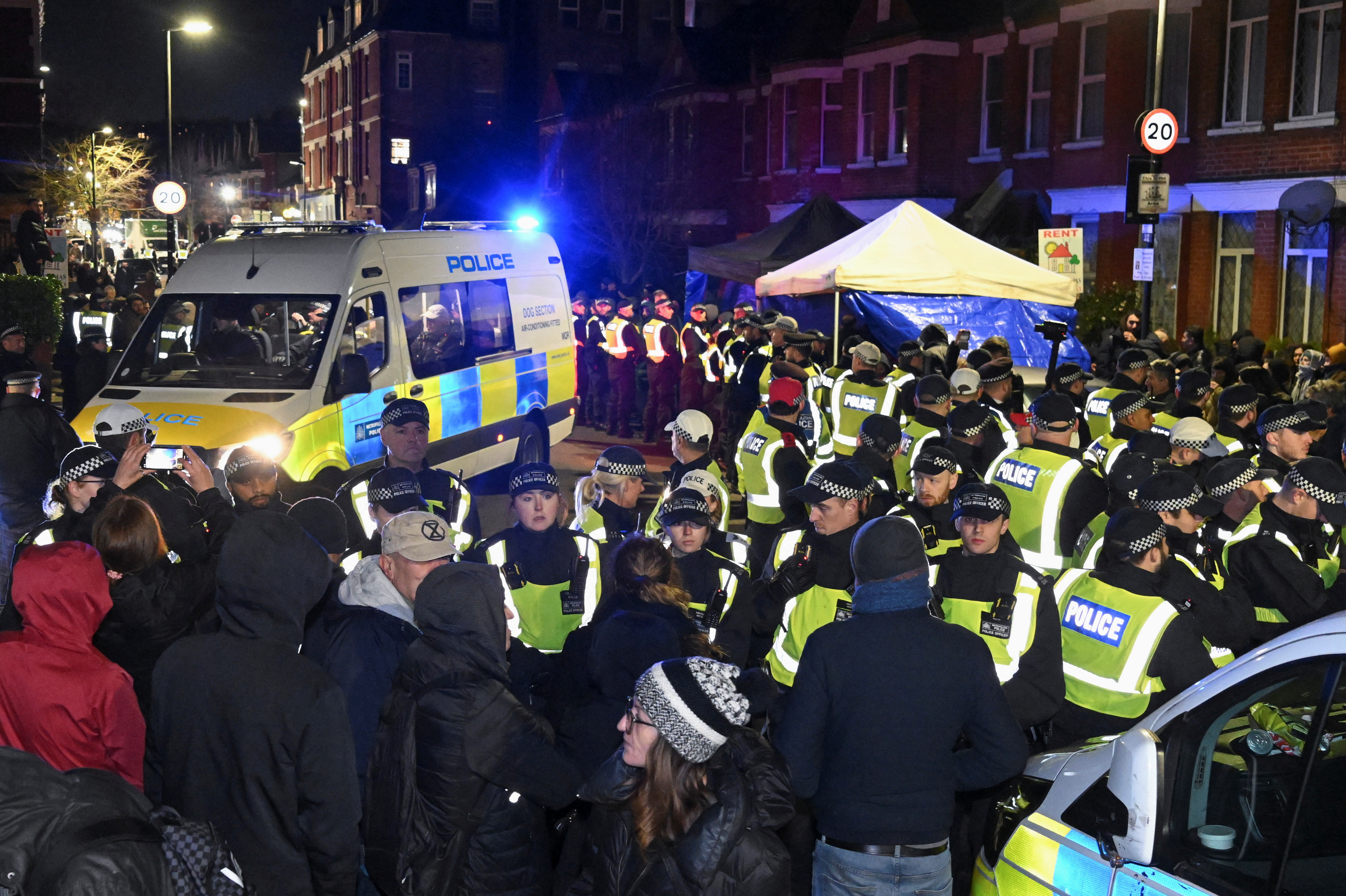 Police stand outside a Kurdish community centre after a counter terrorism investigation into suspected activity linked to the banned Kurdistan Workers Party, in London