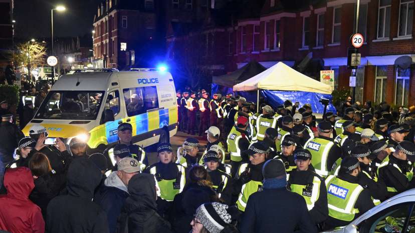Police stand outside a Kurdish community centre after a counter terrorism investigation into suspected activity linked to the banned Kurdistan Workers Party, in London