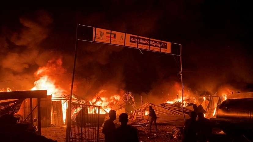 Fire rages following an Israeli strike on an area designated for displaced Palestinians, in Rafah