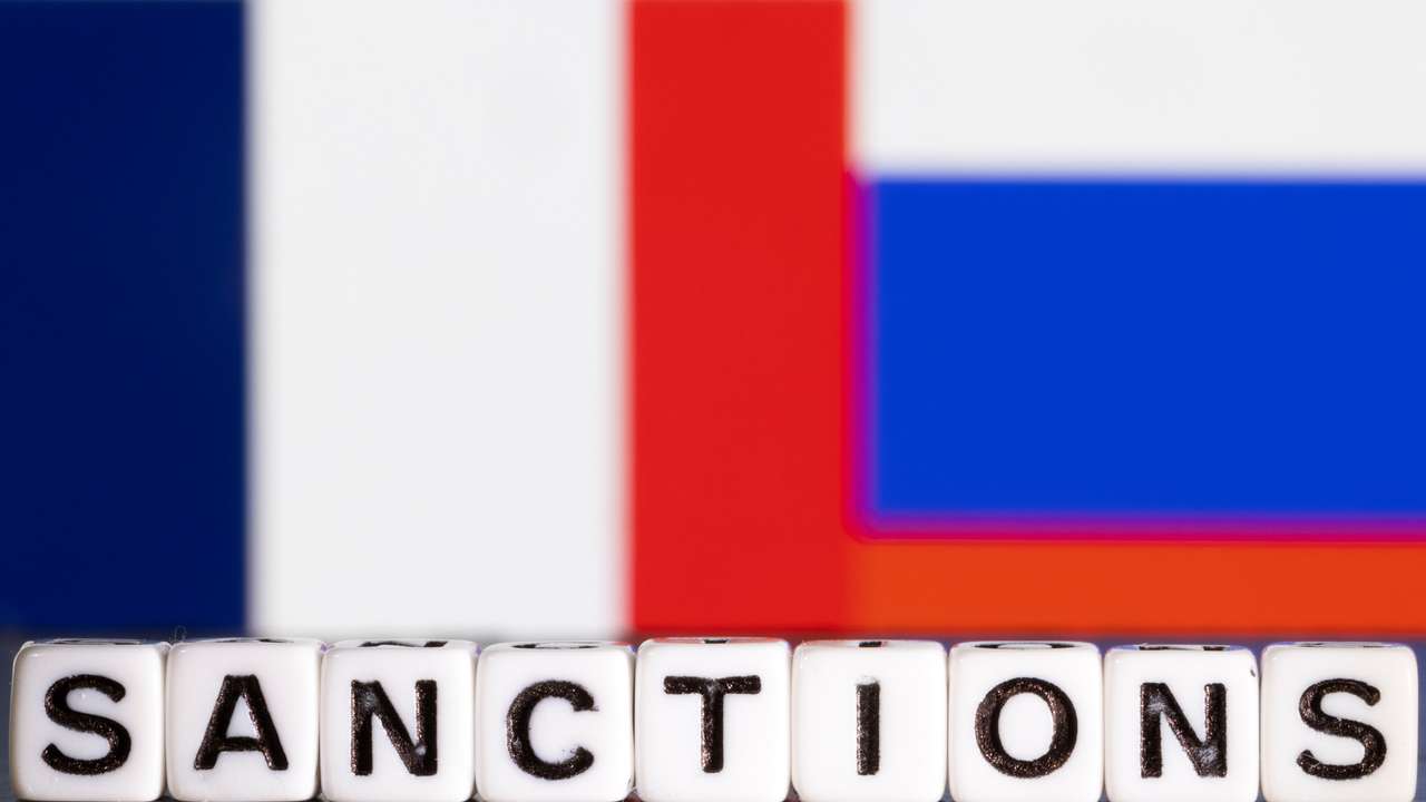 Illustration shows letters arranged to read "Sanctions" in front of flag colors of France and Russia