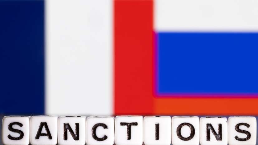 Illustration shows letters arranged to read "Sanctions" in front of flag colors of France and Russia