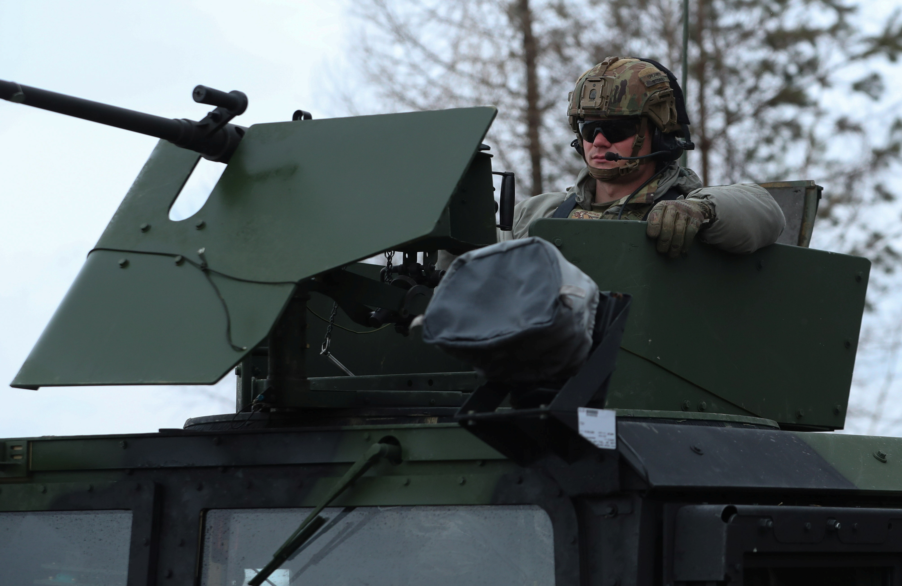 U.S. Army soldiers from the 82nd Airborne Division drive HMMWV (Humvee) vehicle towards an airbase, near Arlamow