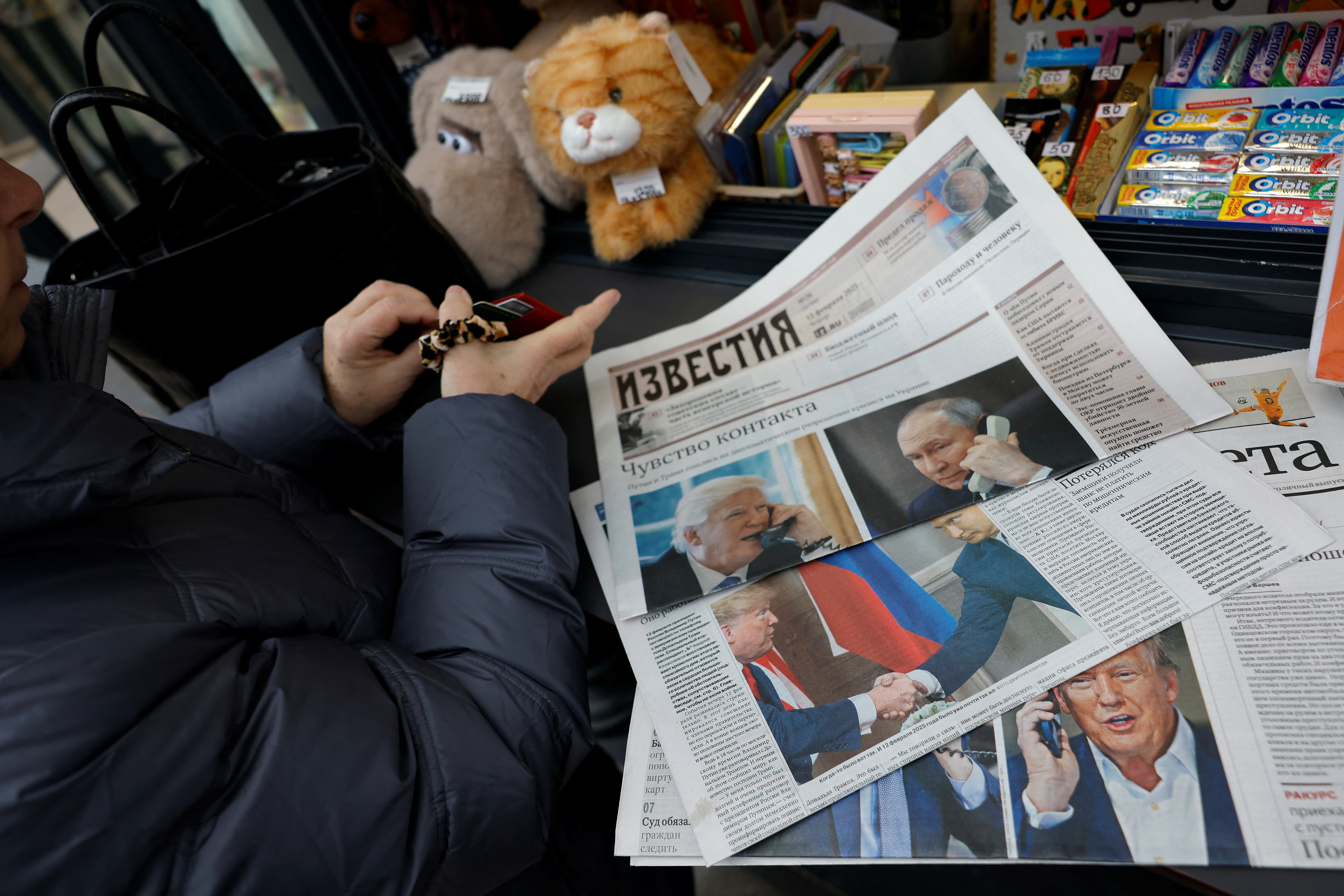 View of newspaper covers dedicated to Putin-Trump phone call at newsstand in Moscow