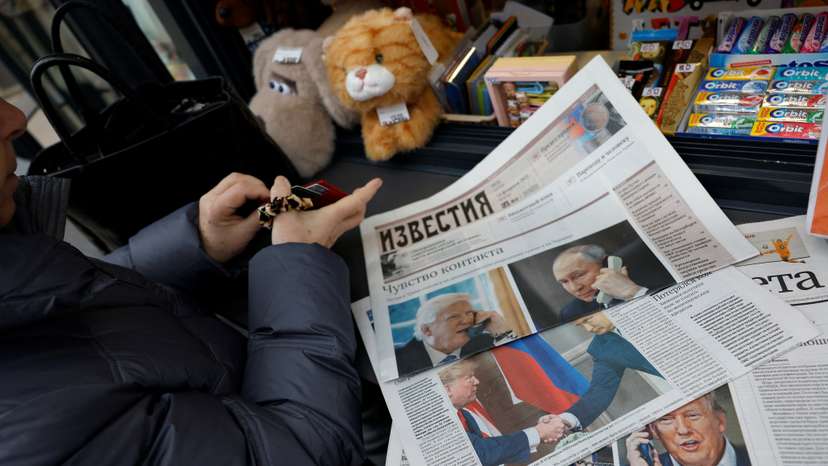 View of newspaper covers dedicated to Putin-Trump phone call at newsstand in Moscow