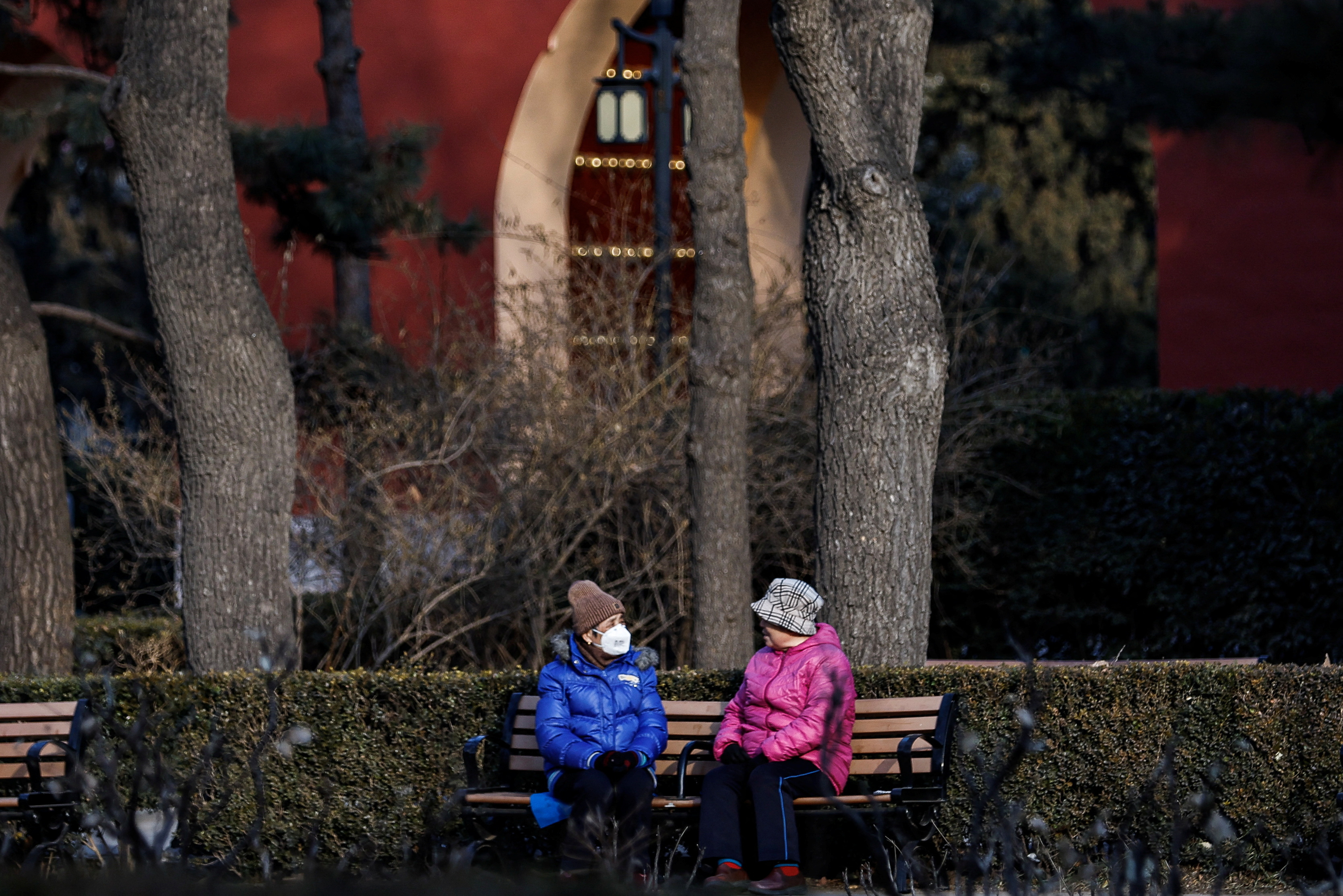 Elderly people rest and chat at a park in Beijing,