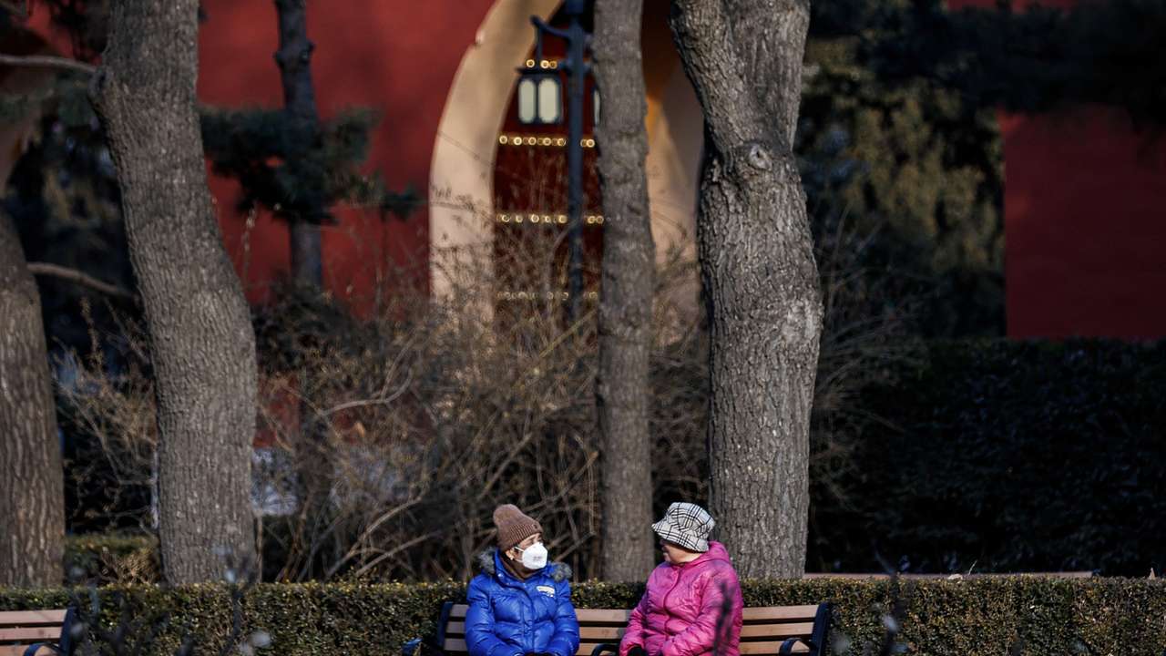 Elderly people rest and chat at a park in Beijing,